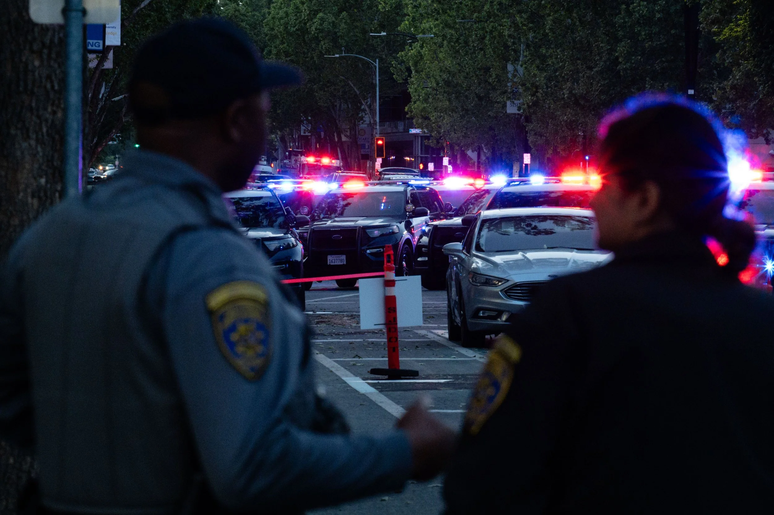 San Jose police cars barricade the entrance of the Colonnade Apartments in San Jose, Calif., on Monday, April 27, 2026. San Jose police officers investigate a family disturbance involving a weapon in the 200 block of South 4th Street. | Thien-An Truo