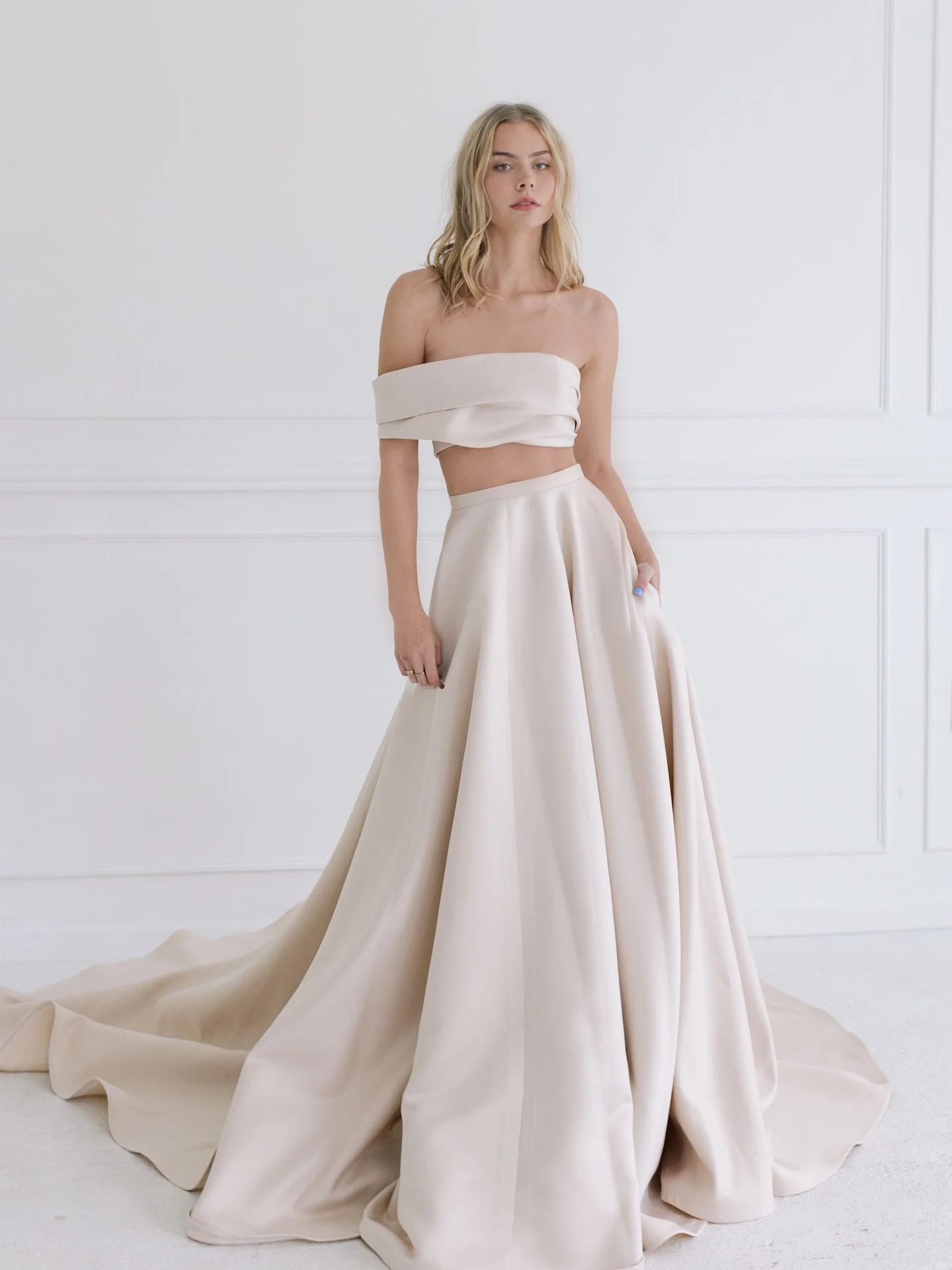 HENRIETTA 🤍✨ TARA LATOUR 2026 Collection 
-Draped Off-The-Shoulder Cropped Corset
-Full A-Line Skirt w/ Pockets and Cathedral Train
-Made in Matte Satin.

Timeless gowns for the romantic bride ✨ Try on HENRIETTA exclusively available at Kinsley Cout