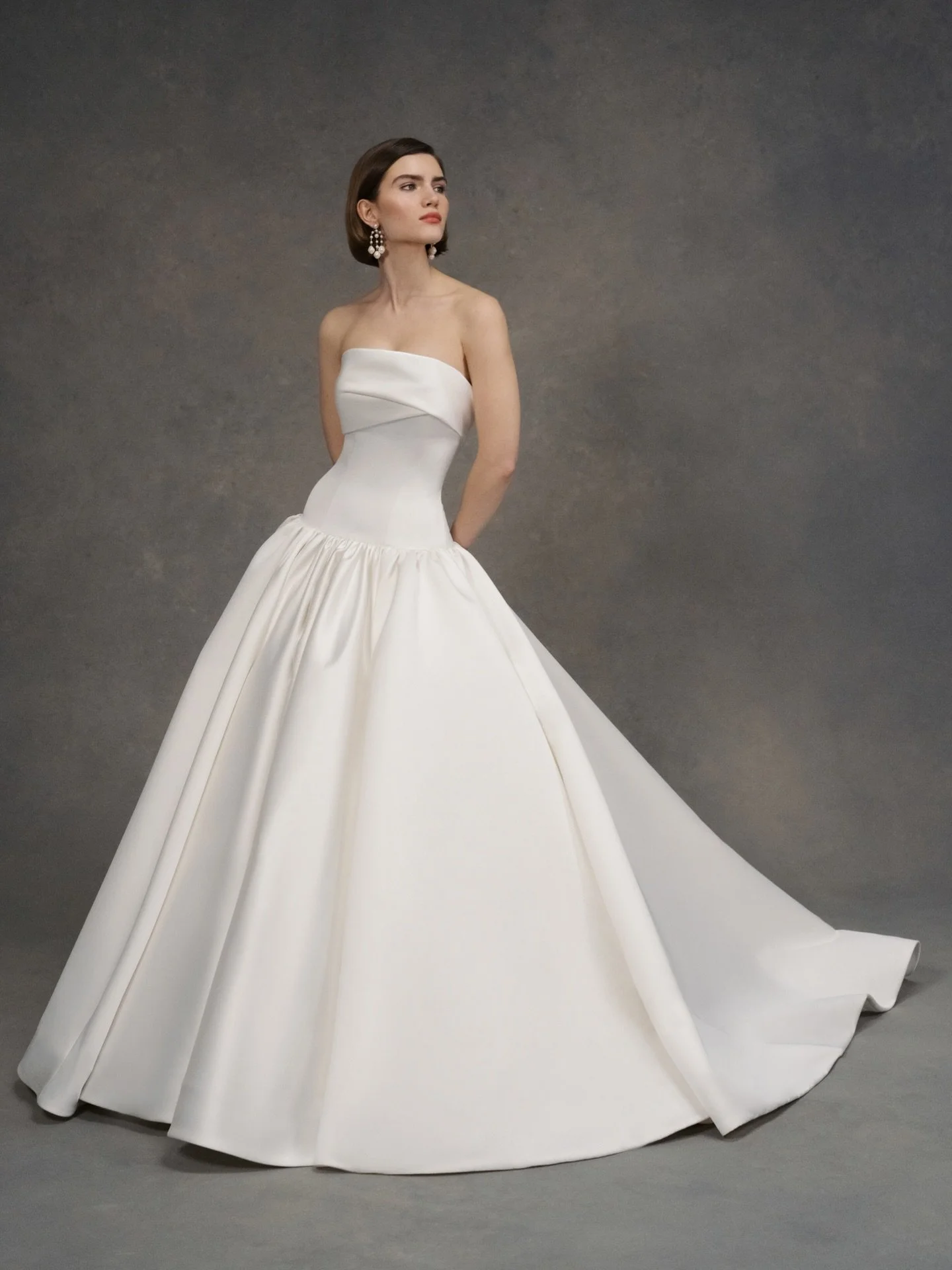 The Dakota wedding dress is a dramatic drop waist mermaid gown in Satin Back Faille with asymmetrically pleated neckline cuff, skirt gathers, and buttons to hem.

 Indulge in the Classic &amp; Timeless looks by ANNE BARGE 🤍 BOOK YOUR APPOINTMENT NOW
