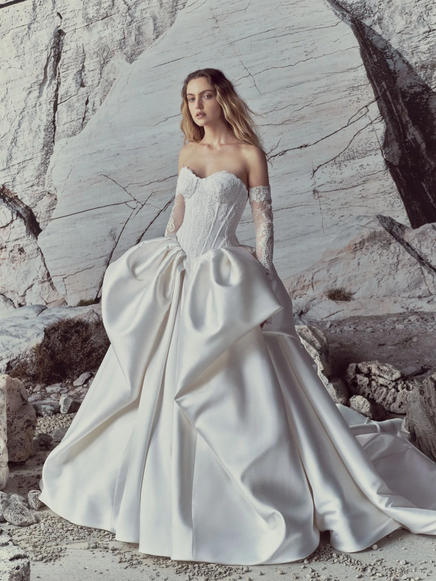 SONNET 🤍 Ballgown with a translucent basque-waist corset hand-applied in Alen&ccedil;on lace. The corset releases into a grand mikado skirt &mdash; deeply pleated, with soft side pickups that gather and fall into a sweeping waterfall below.

Rita Vi