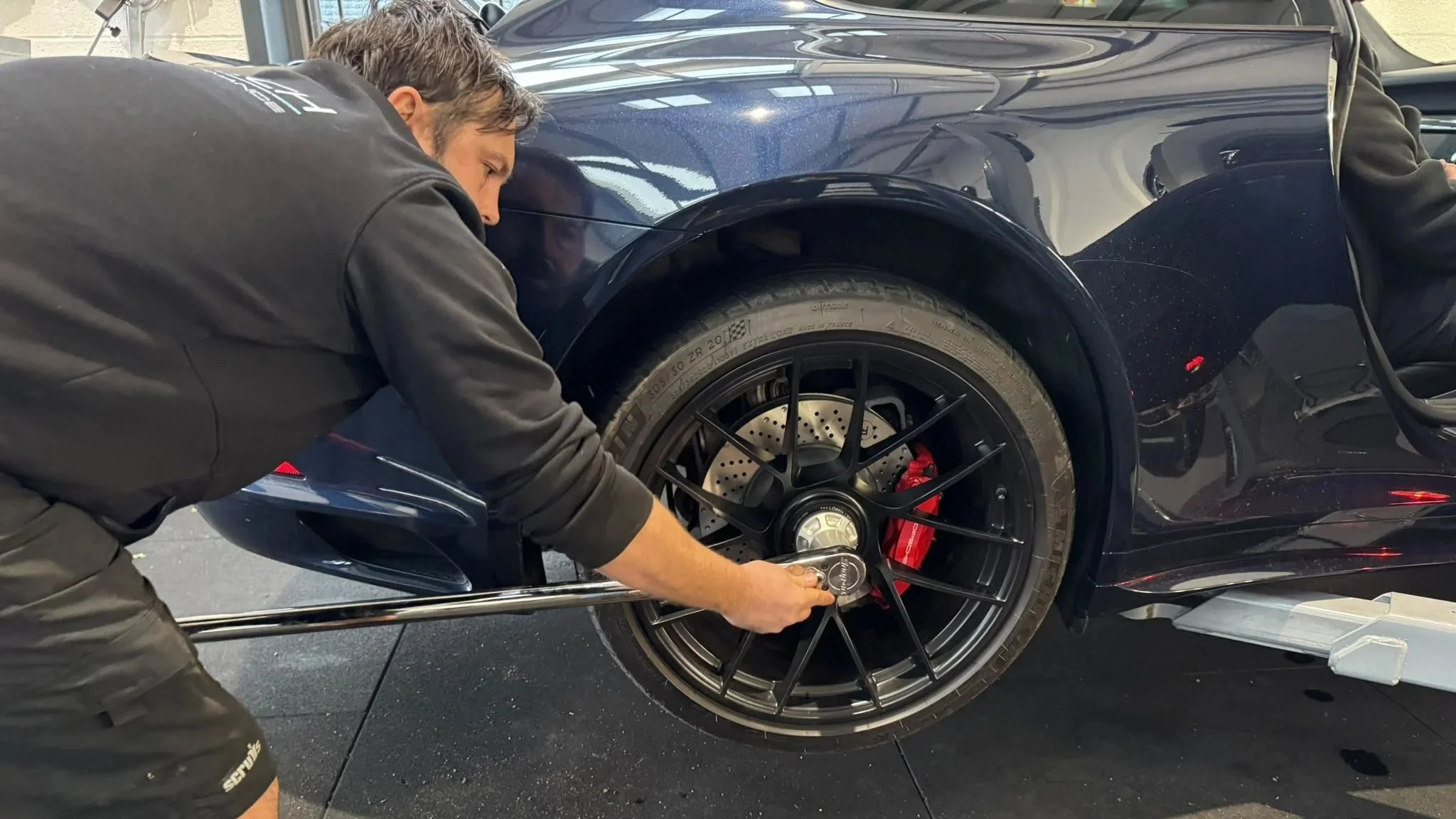 Porsche centre-lock wheel torqued using specialist tooling at Miltech