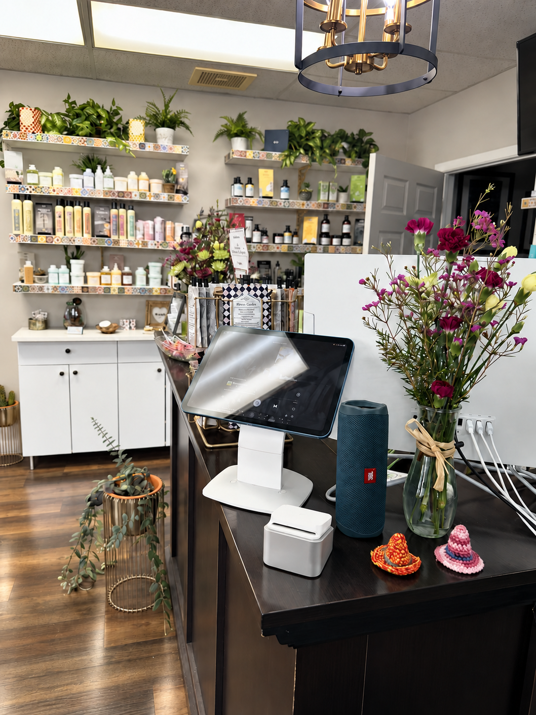 Reception desk at Mechanix + Co. with fresh flowers and Davines haircare.