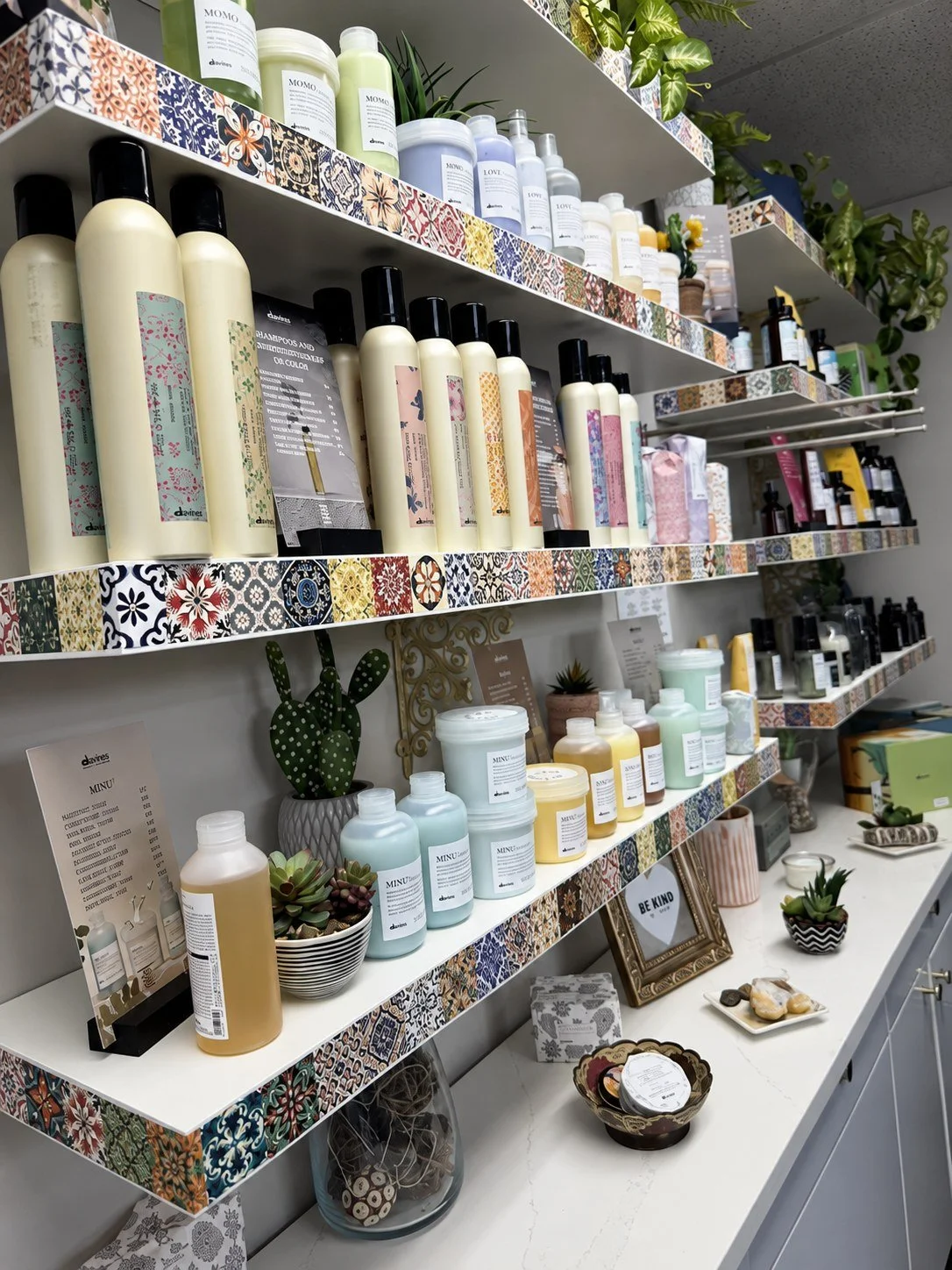 Davines display with a marble countertop, plants, and decorative details at Mechanix + Co.