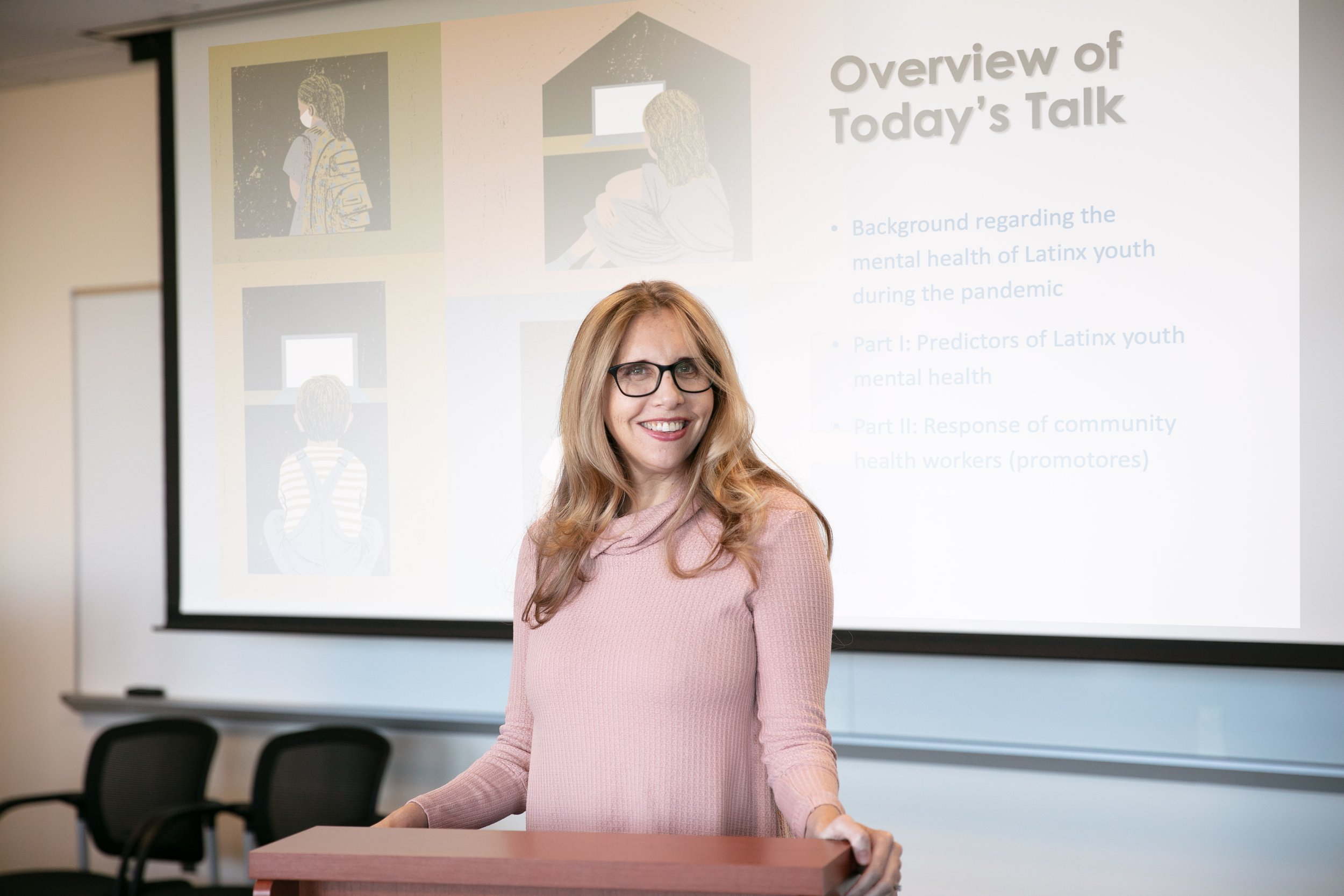Dr. Jessica Borelli (an expert on family relationships and psychology) smiles at the camera