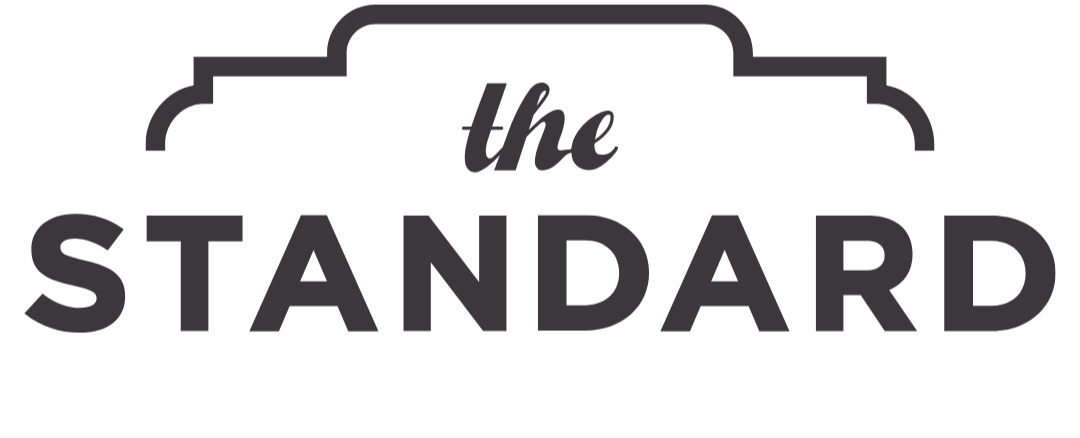 Logo of The Standard with stylized text and decorative border