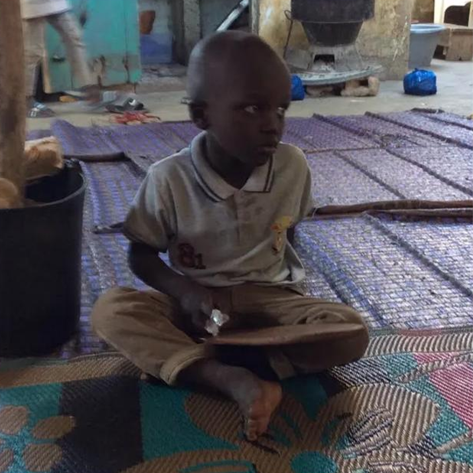 Child student seated on the floor