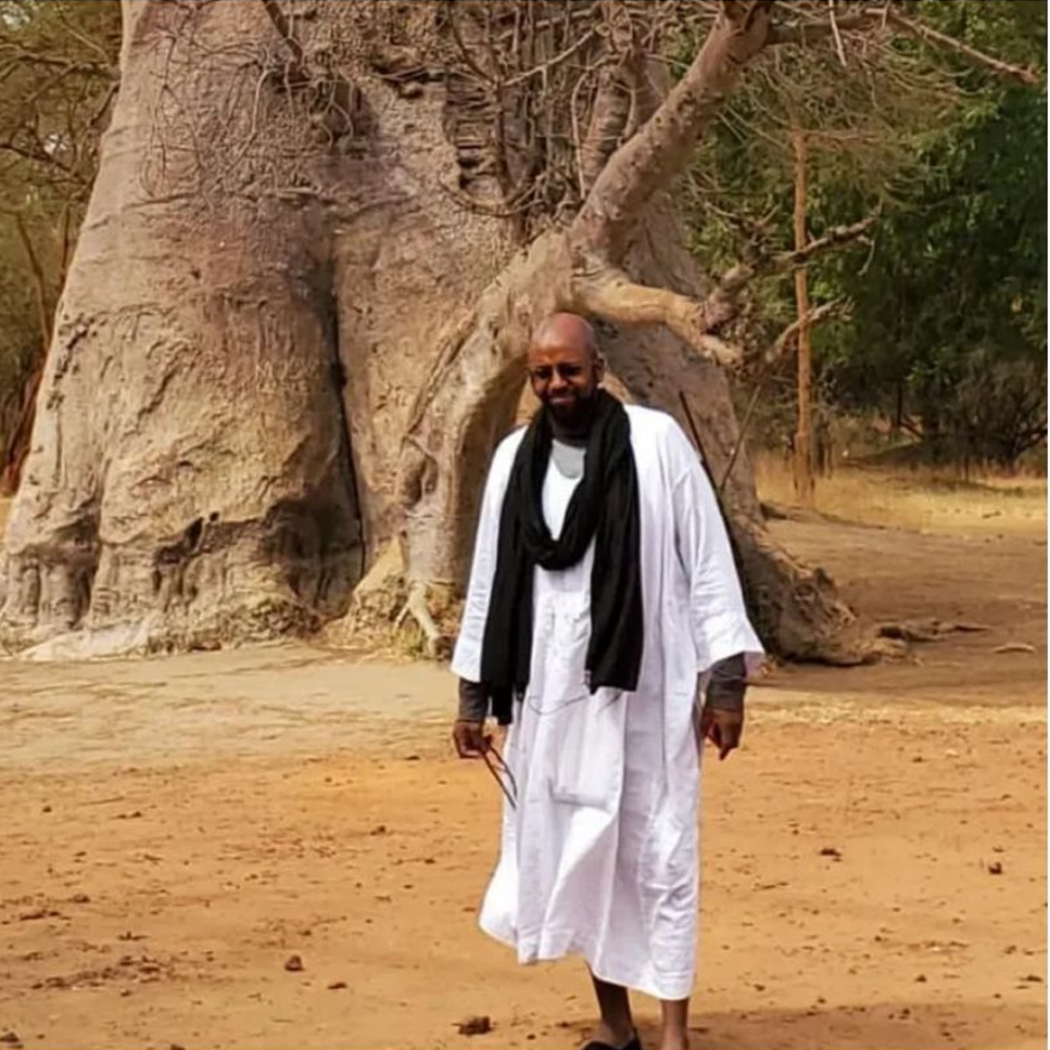 Man standing in front of large tree