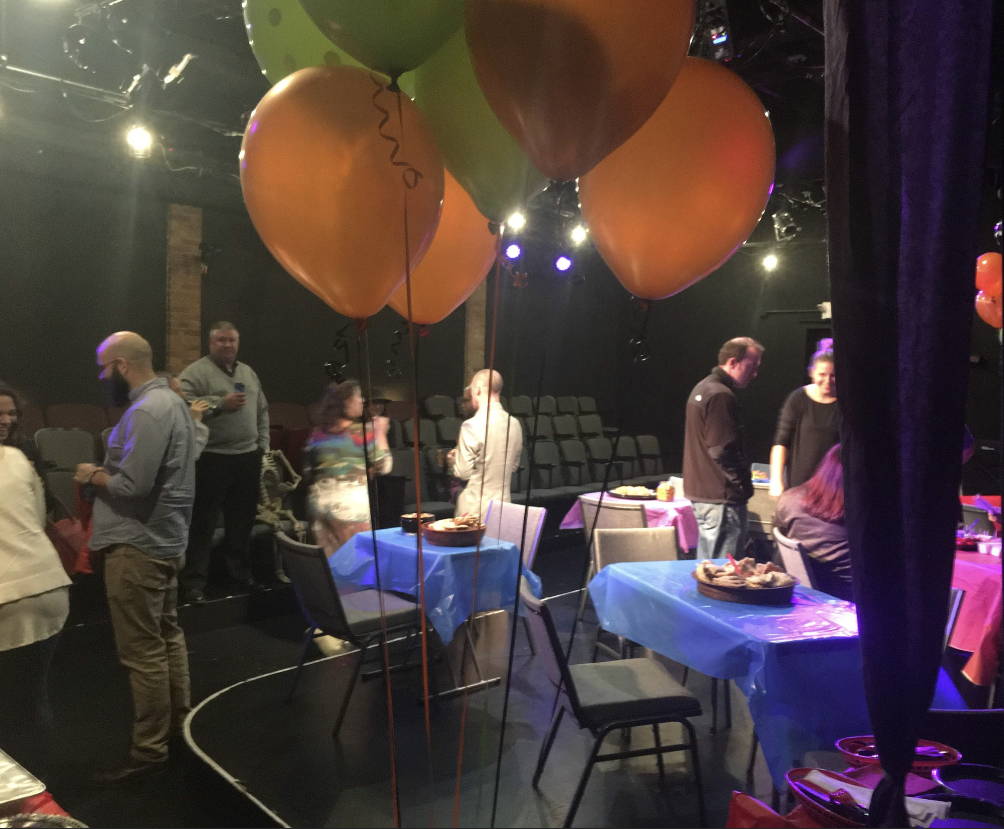 Adults at a party with balloons in foreground