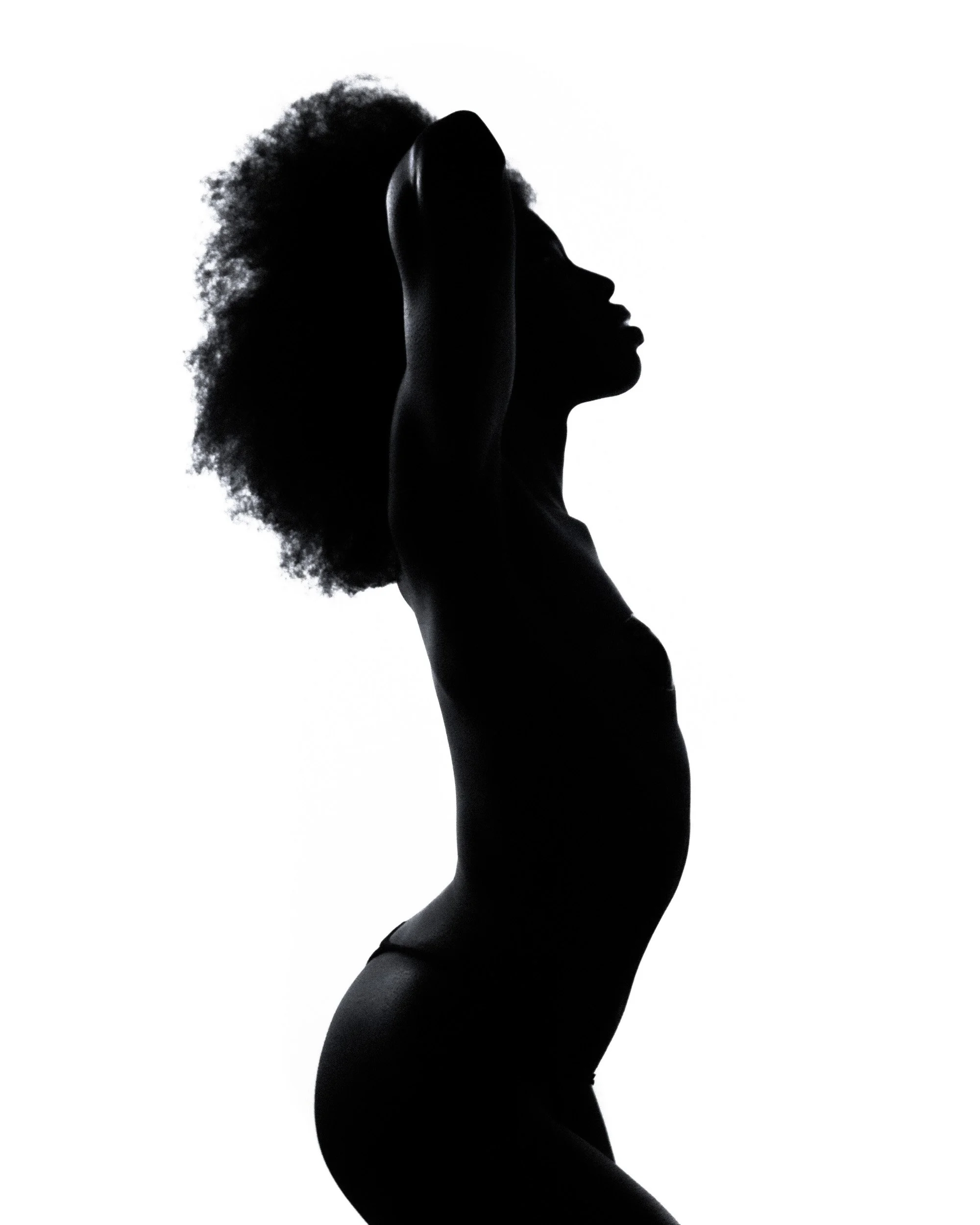 Silhouette of a woman with natural curly hair, her hand resting on her forehead, profile view, black background.