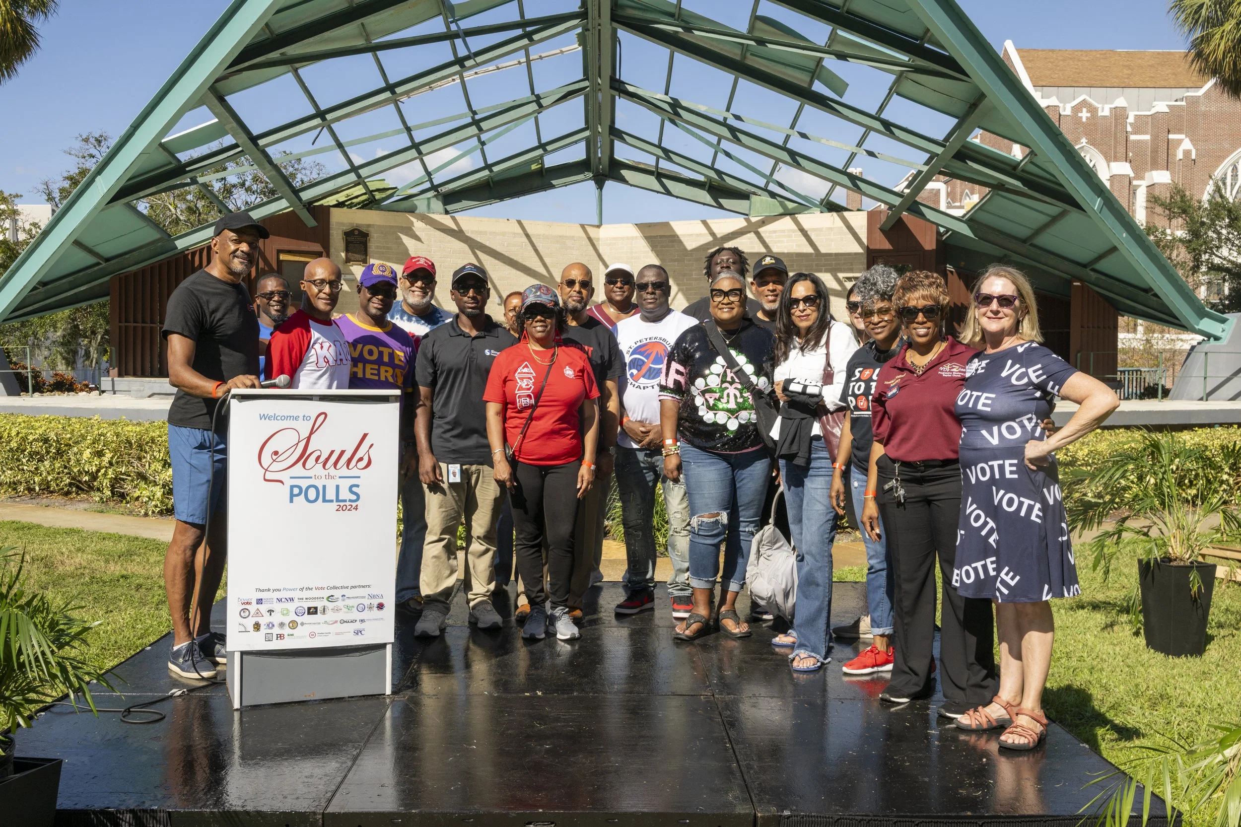 Large group of community members marching in downtown St. Petersburg holding a Pinellas County Urban League “Souls to the Polls – Reclaim Your Vote” banner with youth drummers in front.