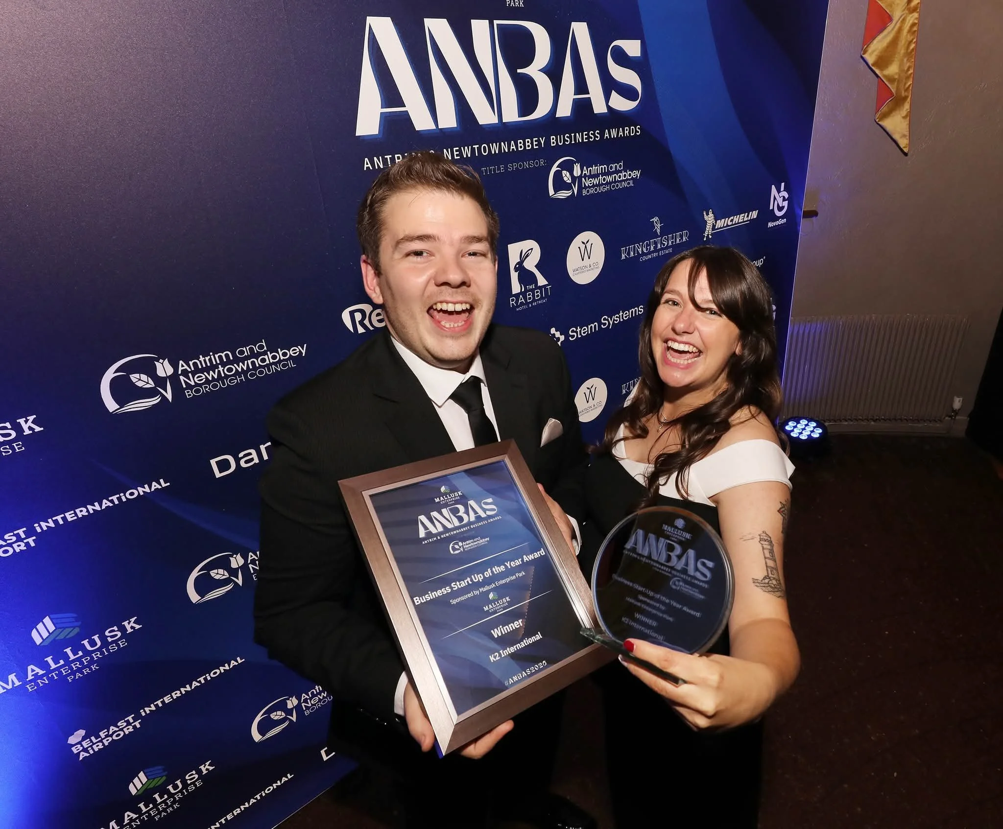 Winners of the Business Start-up of the Year Award, K2 International, hold up their plaque and trophy while cheering