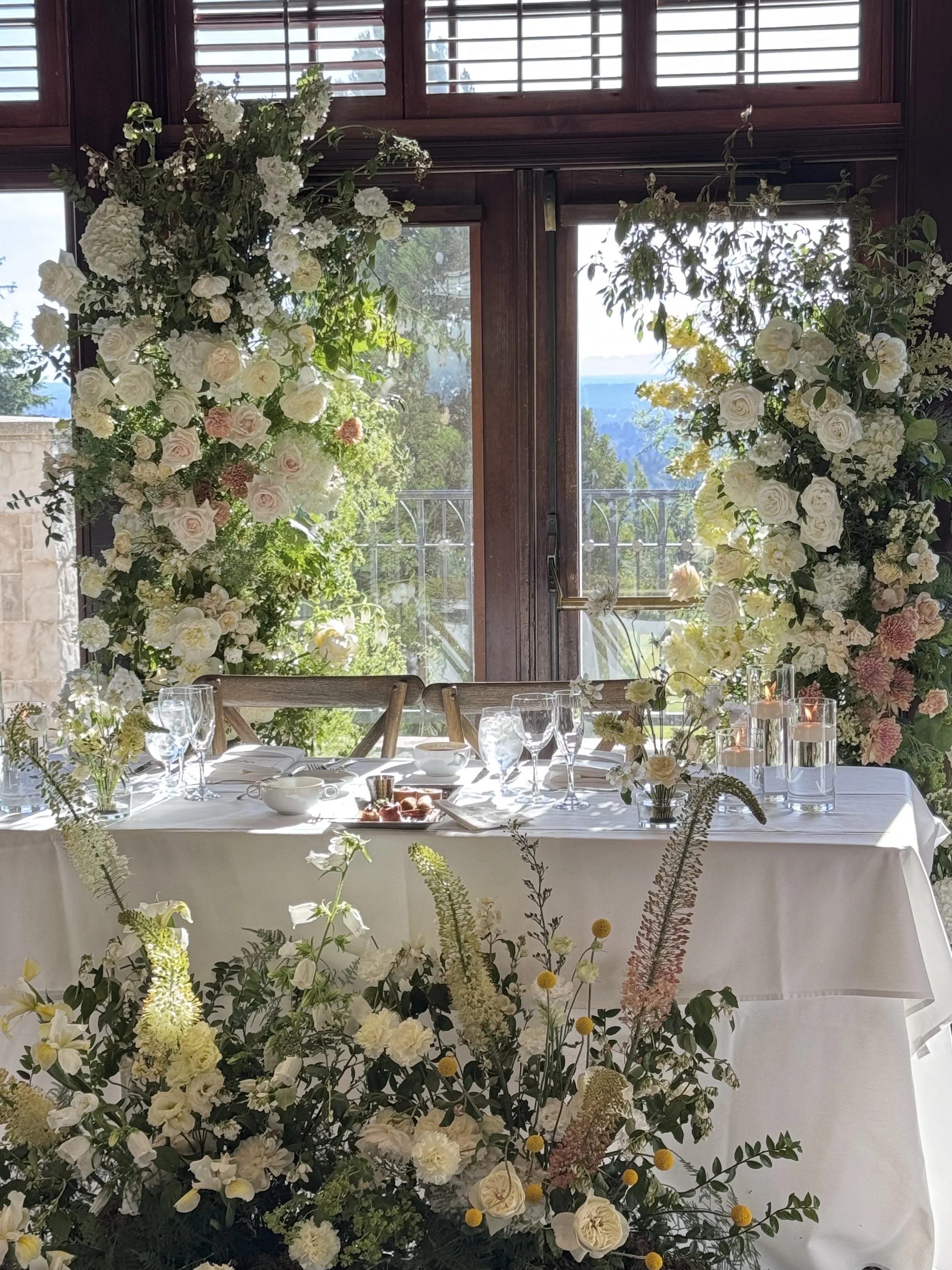 Elegant and whimsical sweetheart table installation, repurposed the ceremony arch.