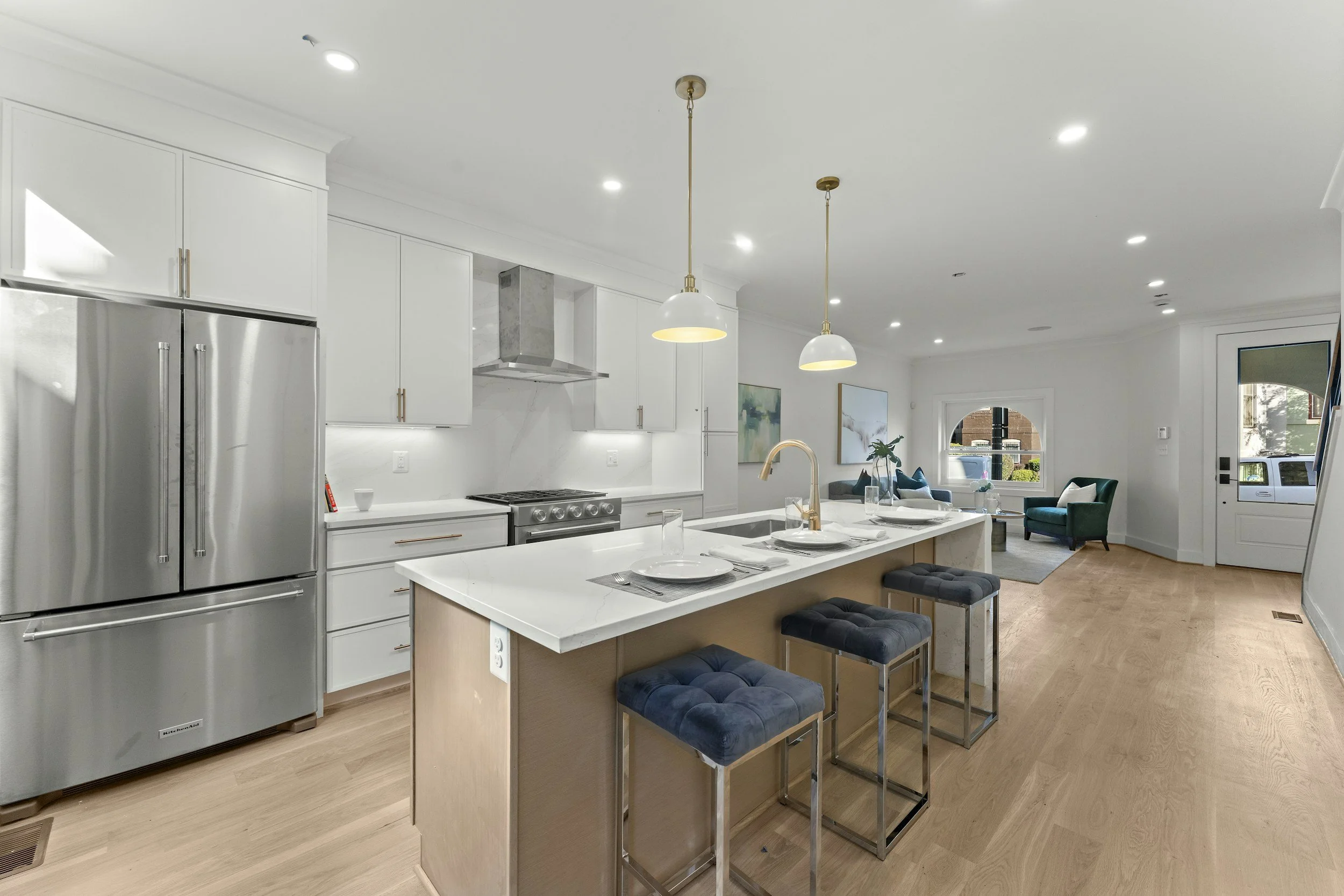 Bright modern kitchen with a stainless-steel refrigerator for refrigerator maintenance guidance.