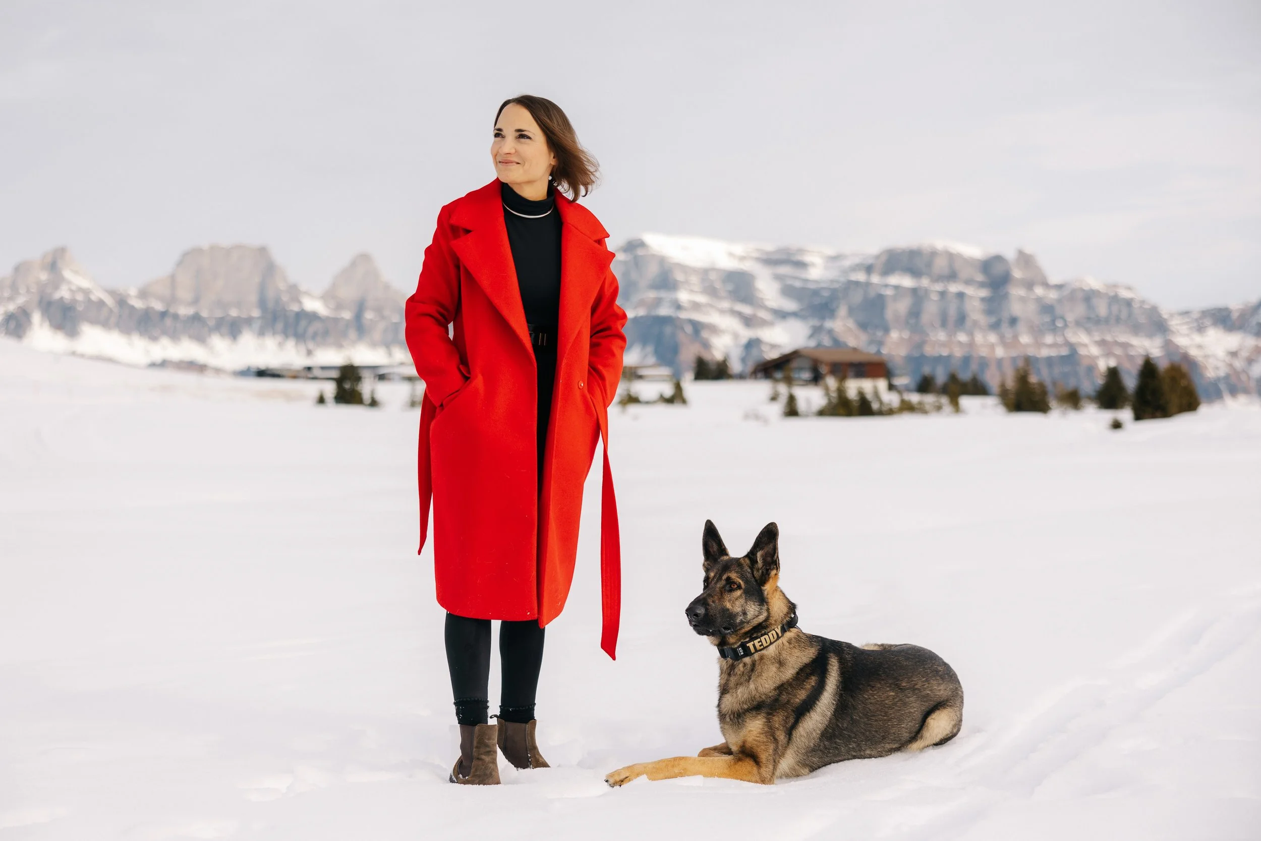 German Shepherd with woman in red coat