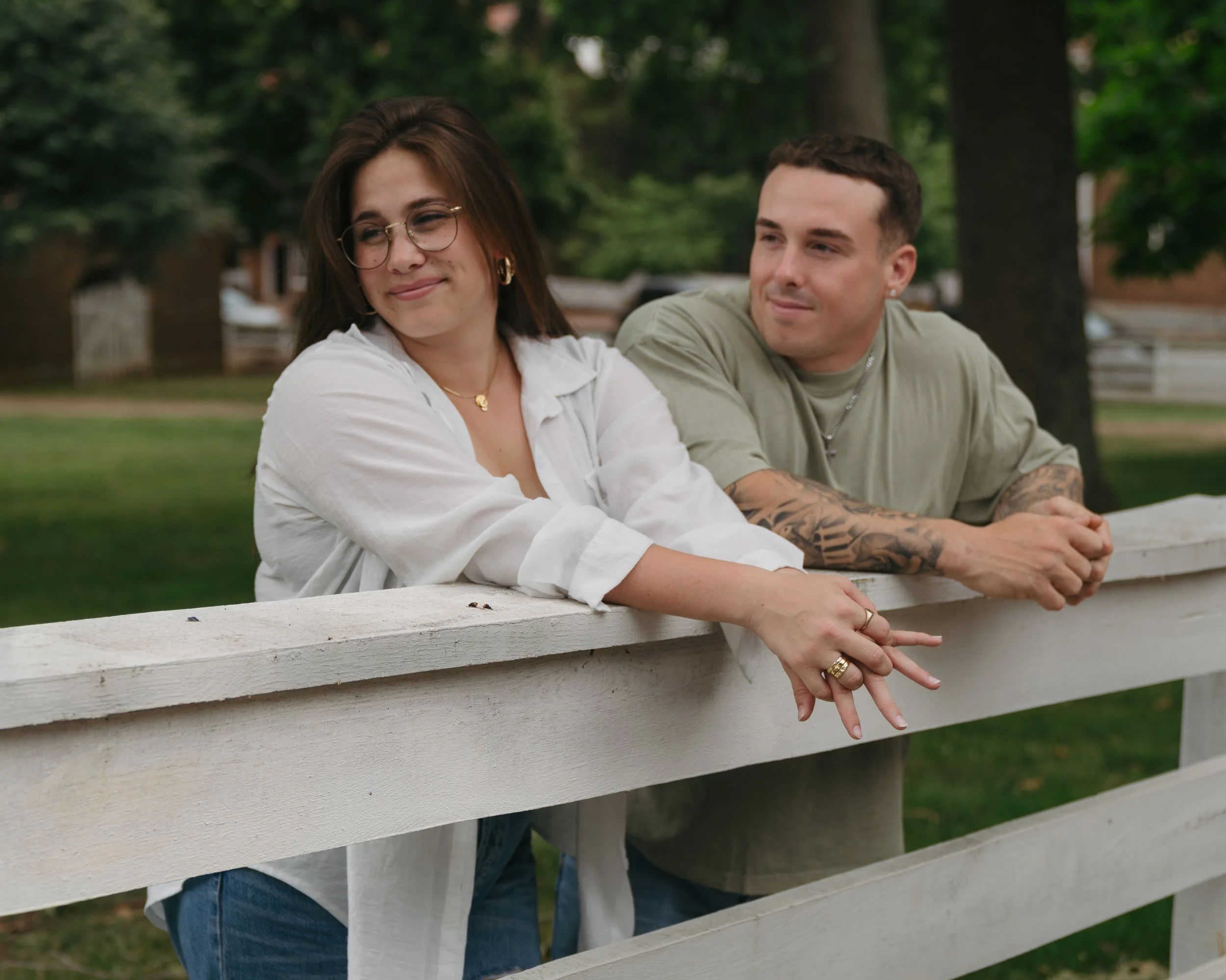 Couple leaning on white fence during romantic Old Salem Winston-Salem couples session