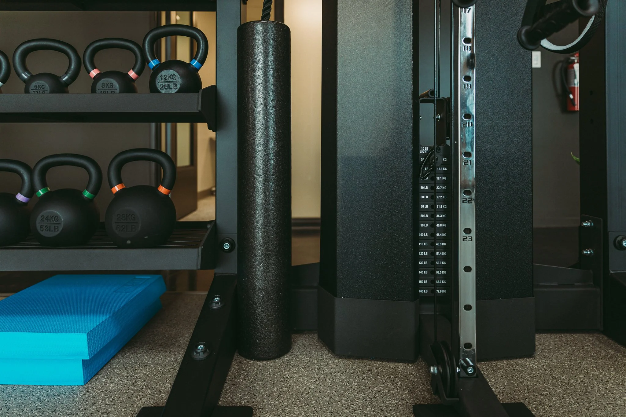A close-up image of kettle bells and other weights in the gym