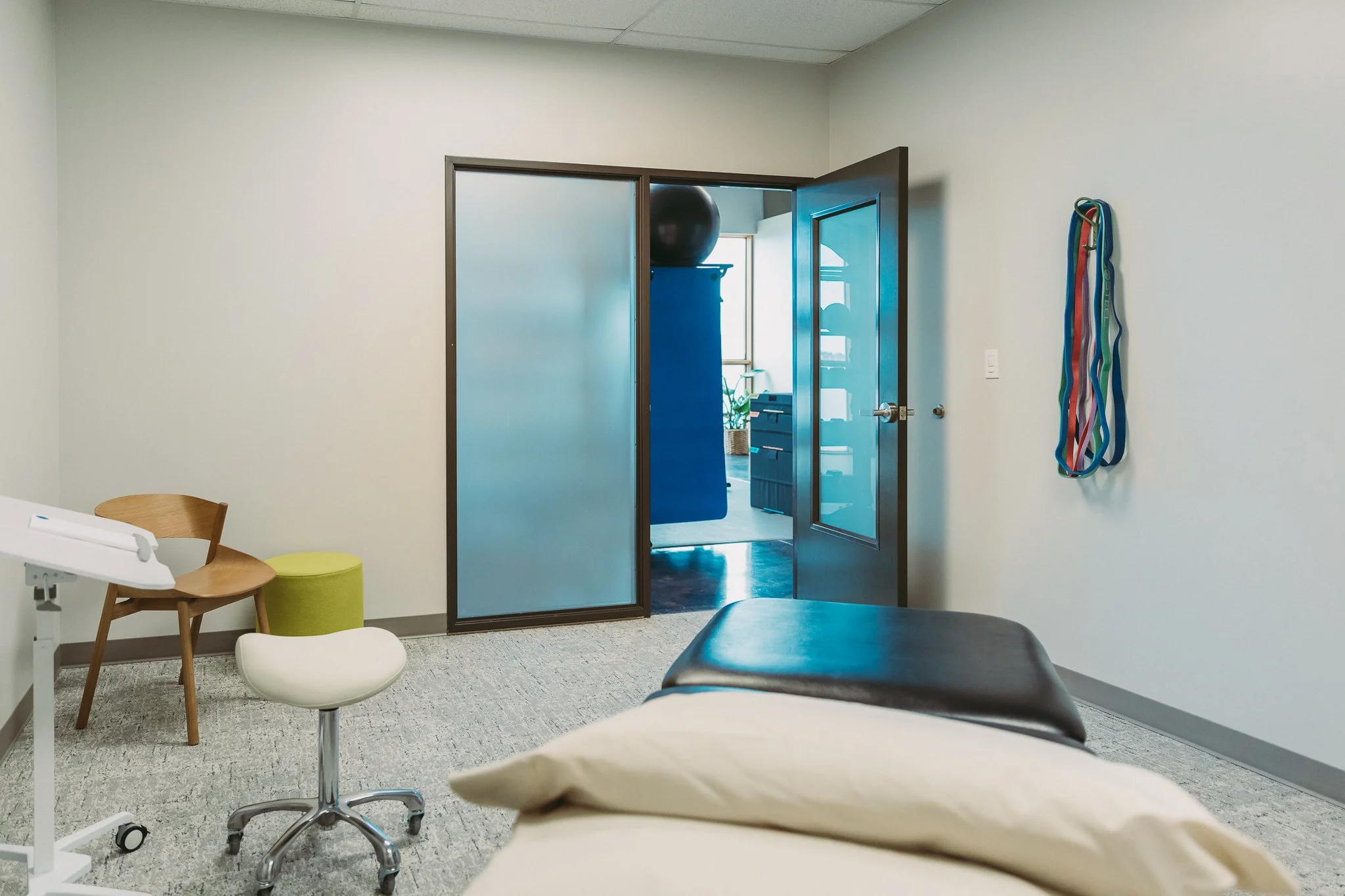 An image of one of the private rooms with a bed, table and chair