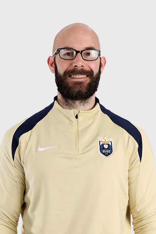 Tom Jobe in gold top with Reign logo