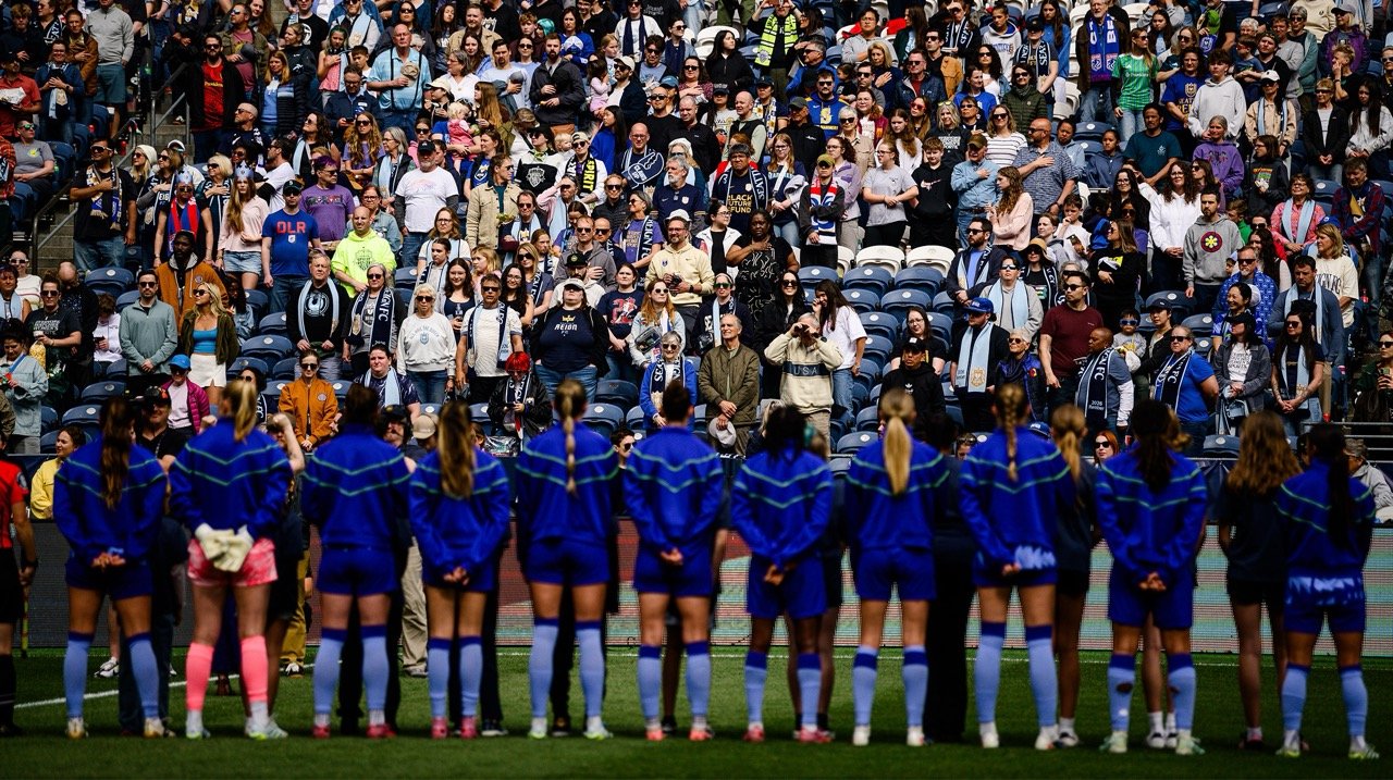 Seattle Reign FC team standing facing the crowd at Lumen Field