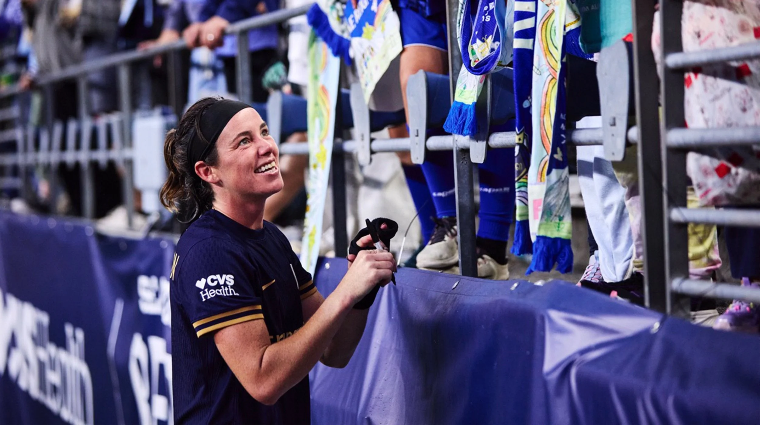 Phoebe McClernon smiling at Reign FC fans in the stands at Lumen Field