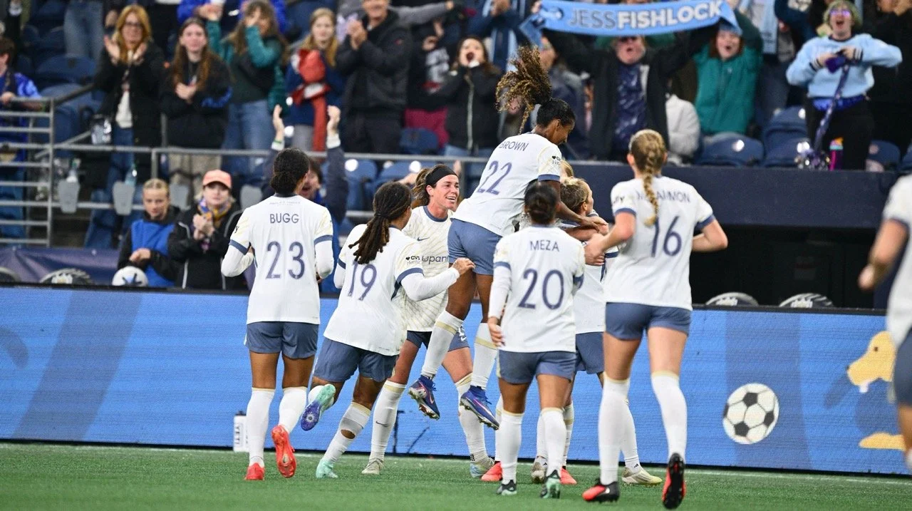 Reign FC team celebrating a goal