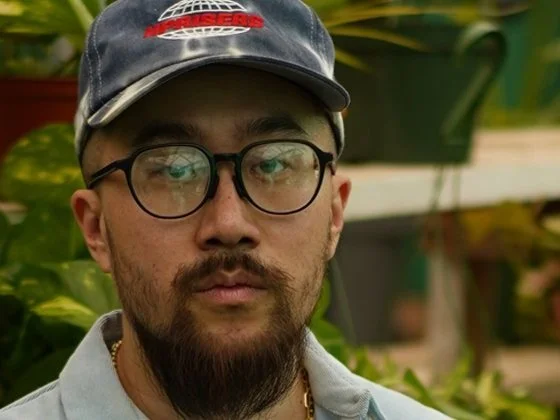 Musical Artist Jason Chu wearing glasses and a blue cap