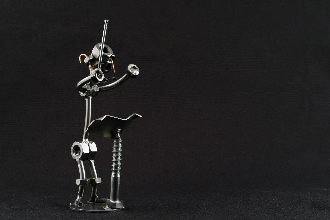 A statue of a conductor made of nuts and bolts