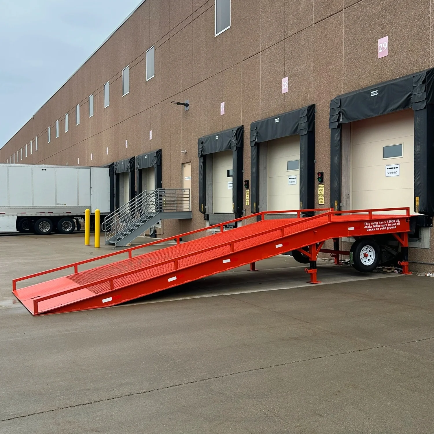 Dock to ground ramp installed at warehouse loading dock