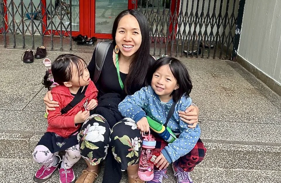 Mother sitting with her 2 daughters