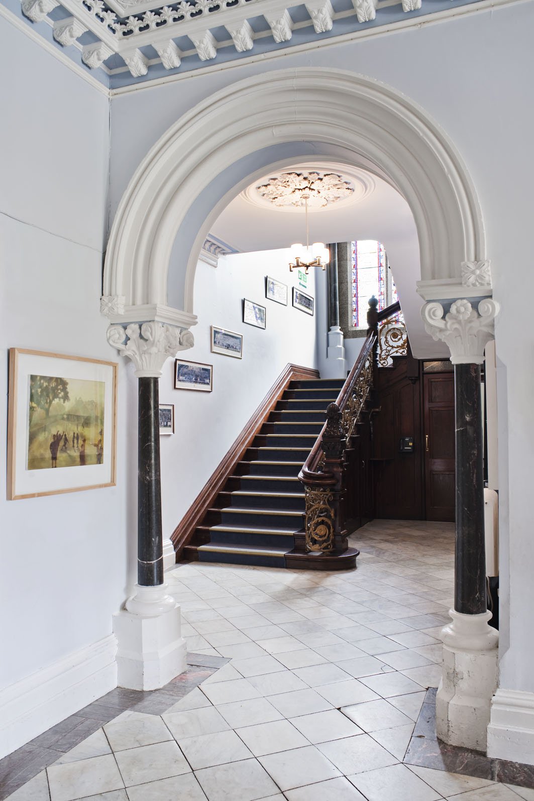 Marble Hallway Leading to Grand Staircase and Stained Glass Window on Landing.jpg
