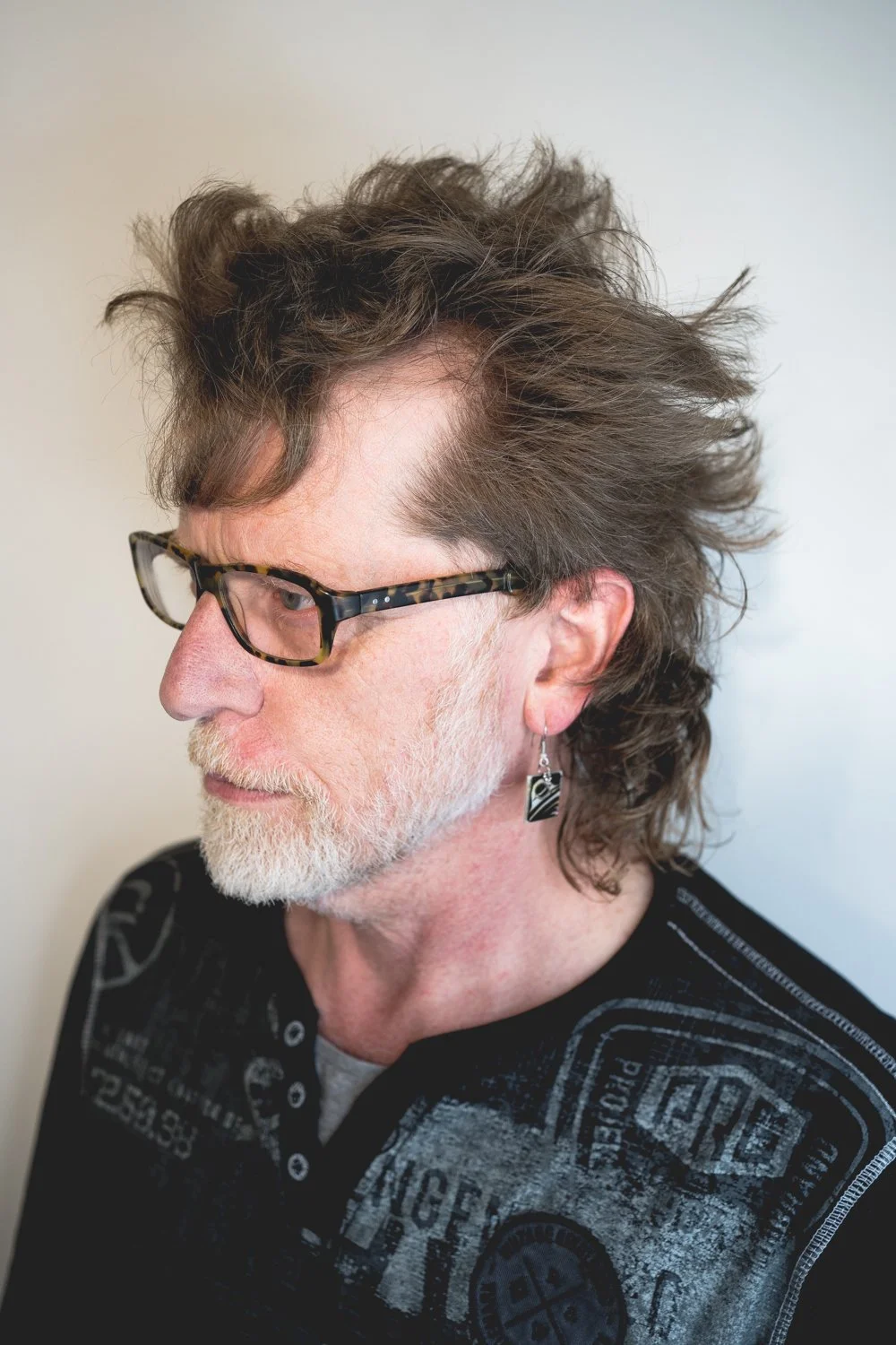 mullet hairstyle on older man that looks cool and creative with lots of texture and pieced out bits