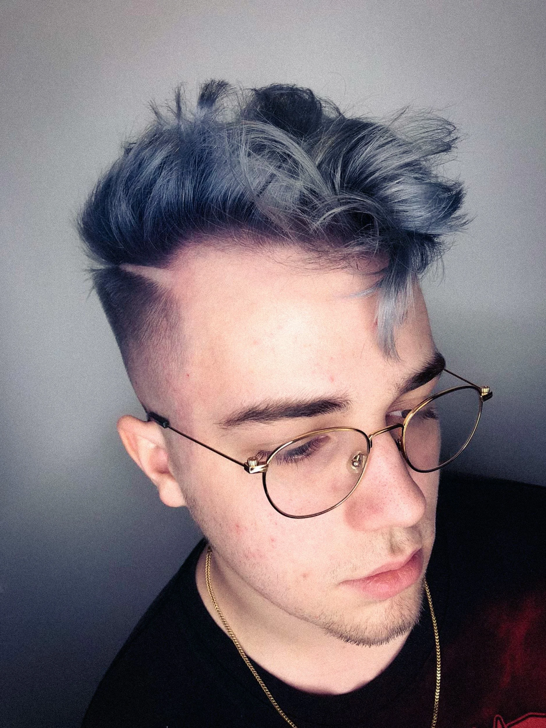 mens blue grey creative color with skin fade and curly textured flow on top