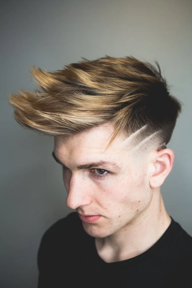 male haircut and highlights with creative design shaved in sides with skin fade and long textured top length
