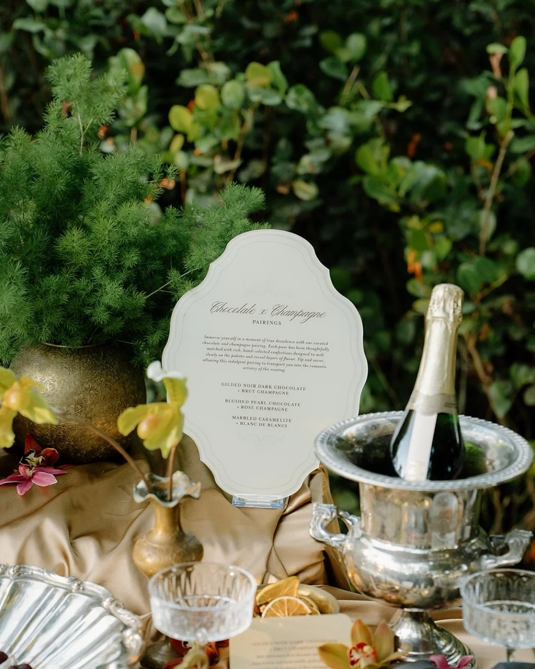 Love, Gilded served temptation on a silver platter.

We designed the signage to live within the tablescape &mdash; echoing the gold, mirroring the depth, holding its own among chocolate and champagne.

Because in a setting this rich, signage isn&rsqu
