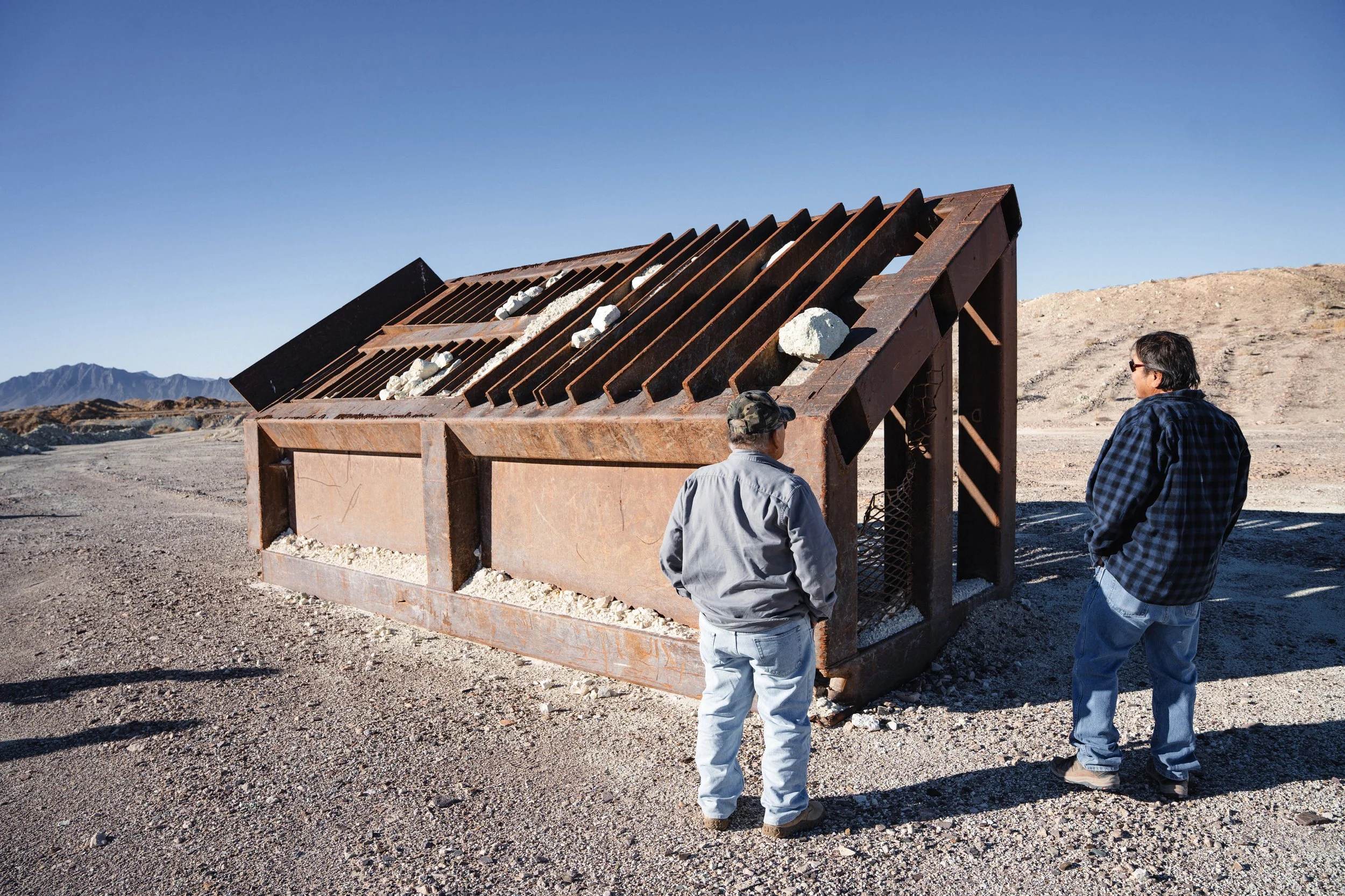 Elders of the Timbisha Shoshone tribe Ted James (left) and Calvin Watterson (right) look at an idle sifter used to mine clinoptilolite near Death Valley Junction, Calif.