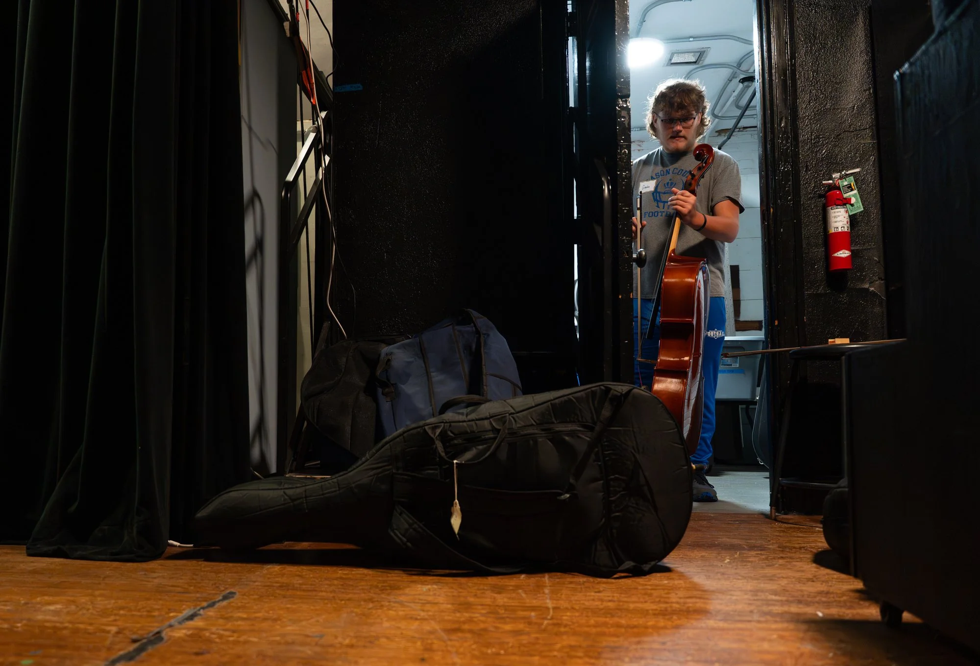 Gavin grabs his cello before a rehearsal for the Mason County Orchestra’s fall concert in Maysville, Ky., Oct. 23, 2025. He sits first chair and will perform as a soloist that evening.