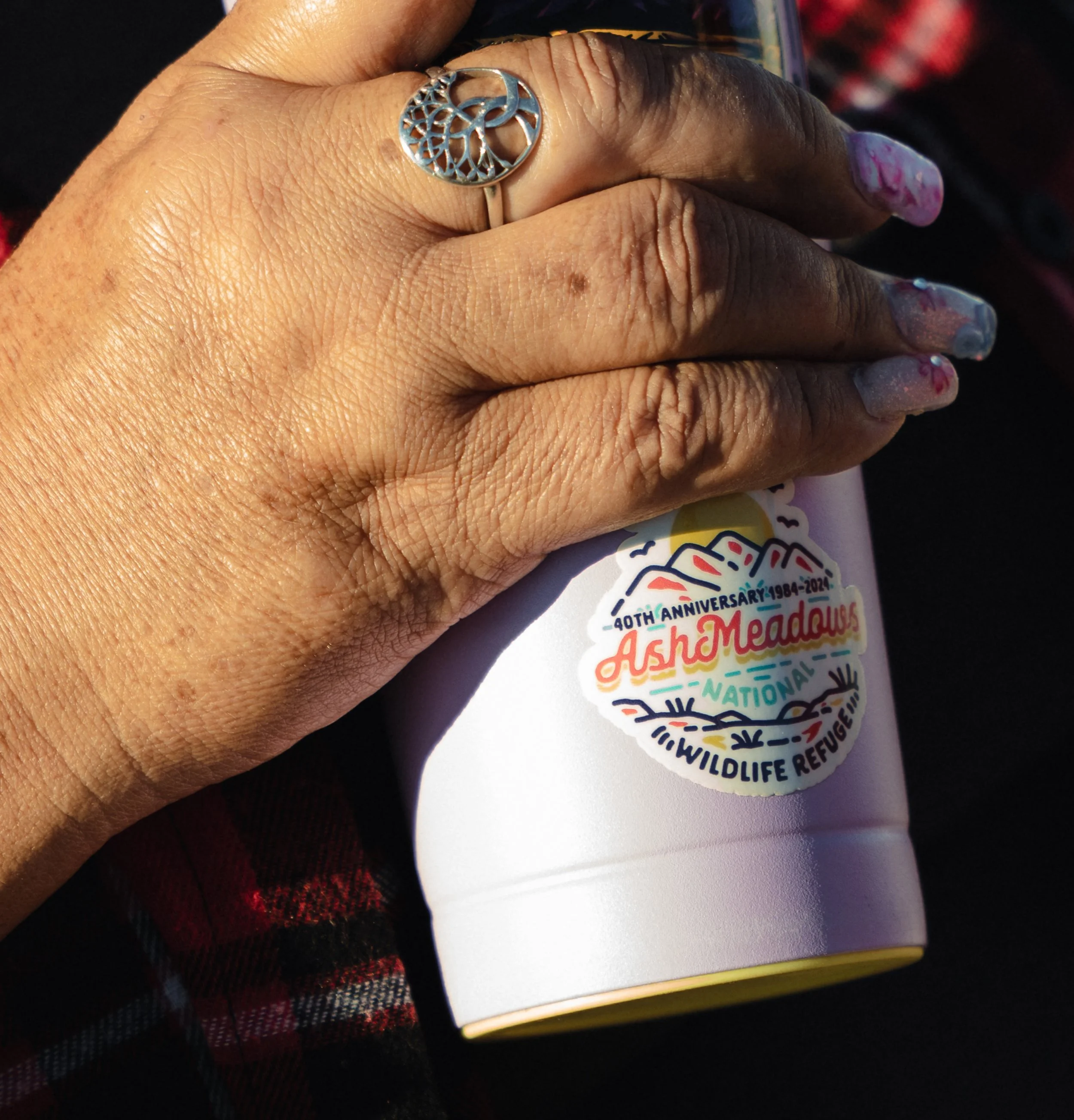 Mandi Campbell, historic preservation officer for the Timbisha Shoshone Tribe, holds her thermos decorated with a sticker from the neighboring reserve.