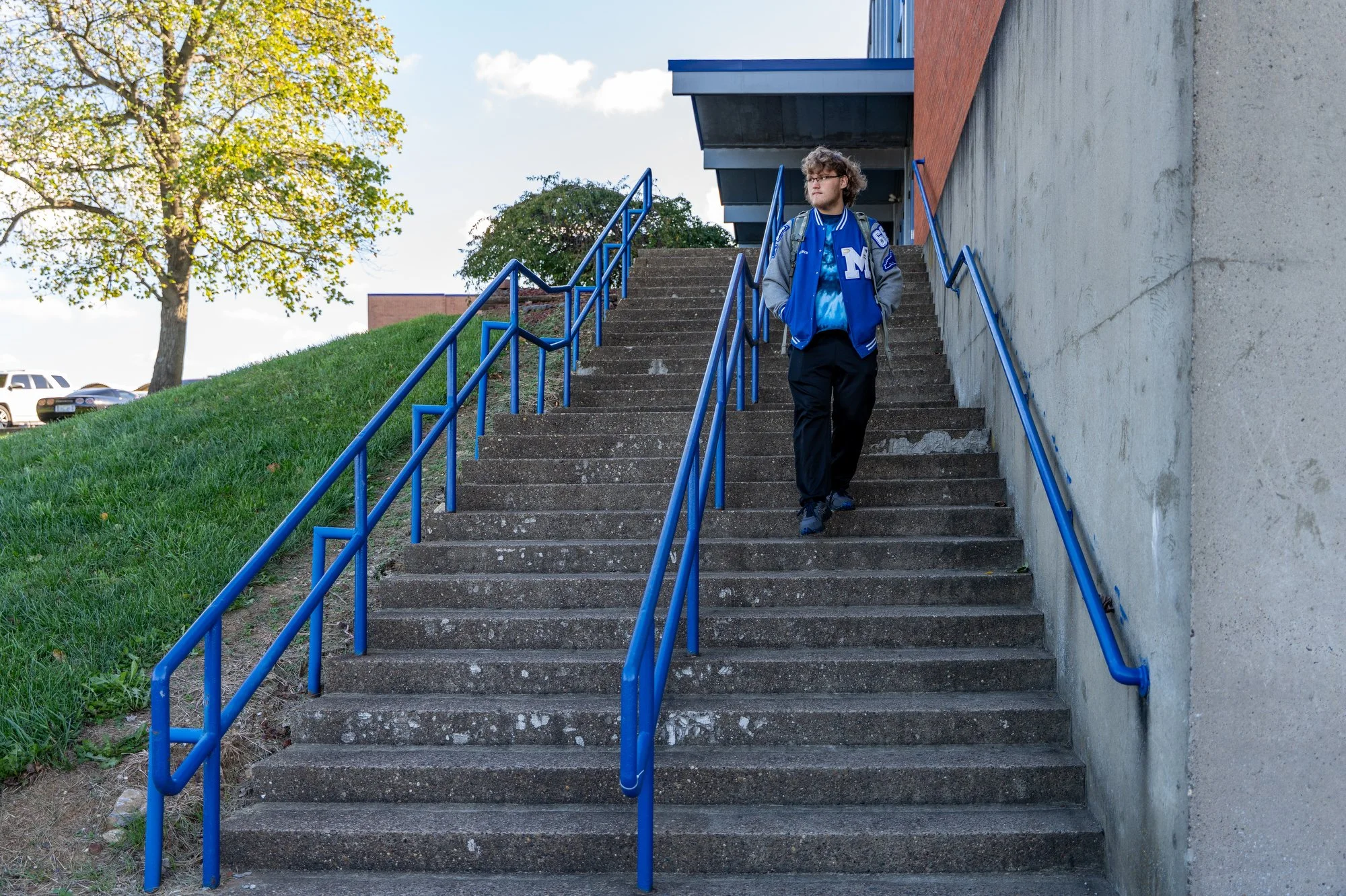 Gavin Redmond, 18, walks to his car outside Mason County High School before heading across town to his woodworking class at another campus Oct. 22, 2025.