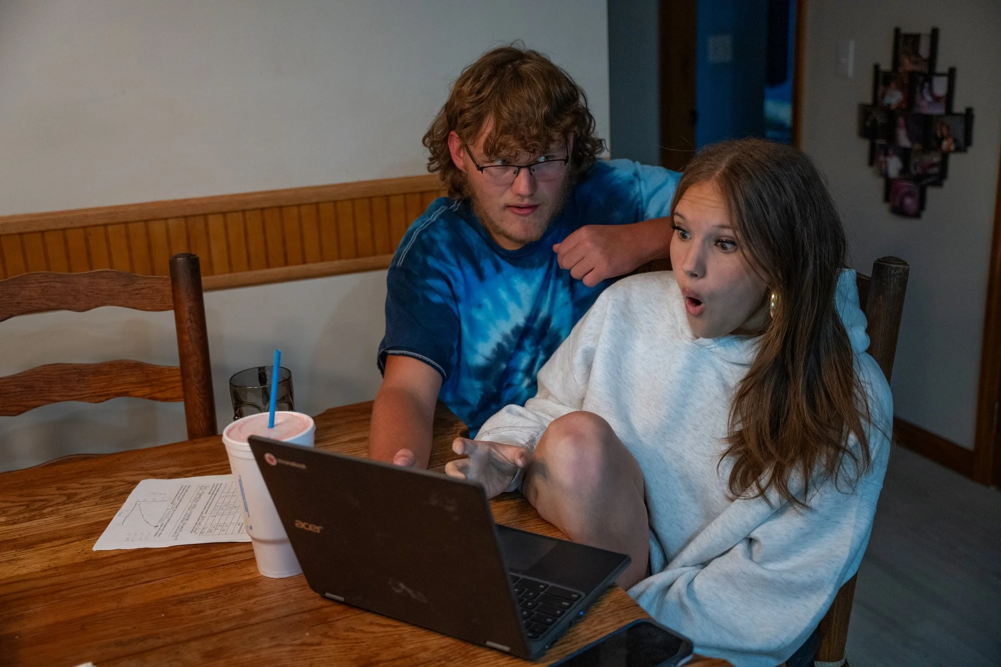 Gavin Redmond, 18, helped his sister, Claire, 16, with her physics homework after dinner at their home about 15 minutes outside downtown Maysville on Oct. 22, 2025.