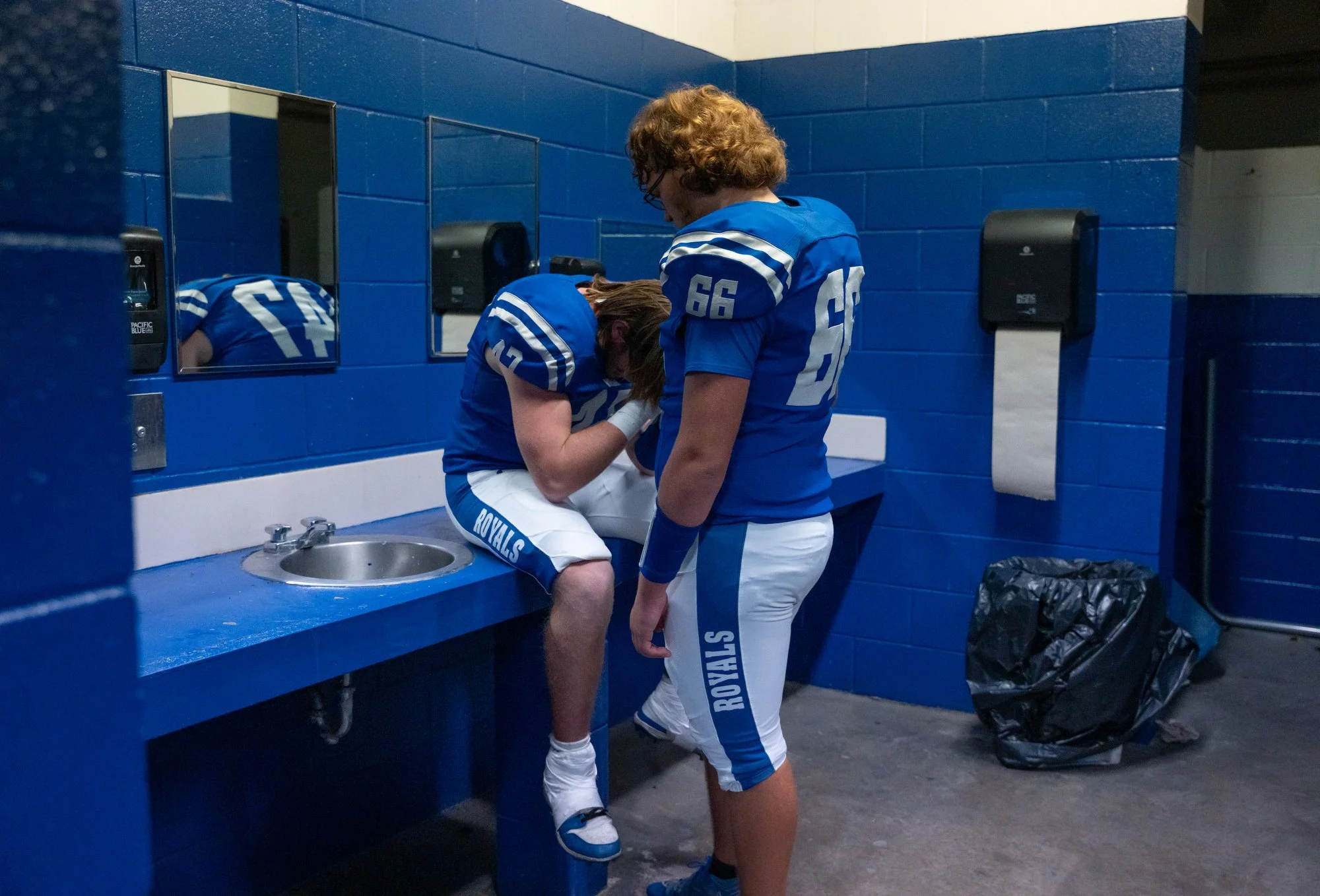 Gavin comforts a fellow senior teammate during halftime as the score widened against Mason County at Mason County High School in Maysville, Ky., Oct. 24, 2025.