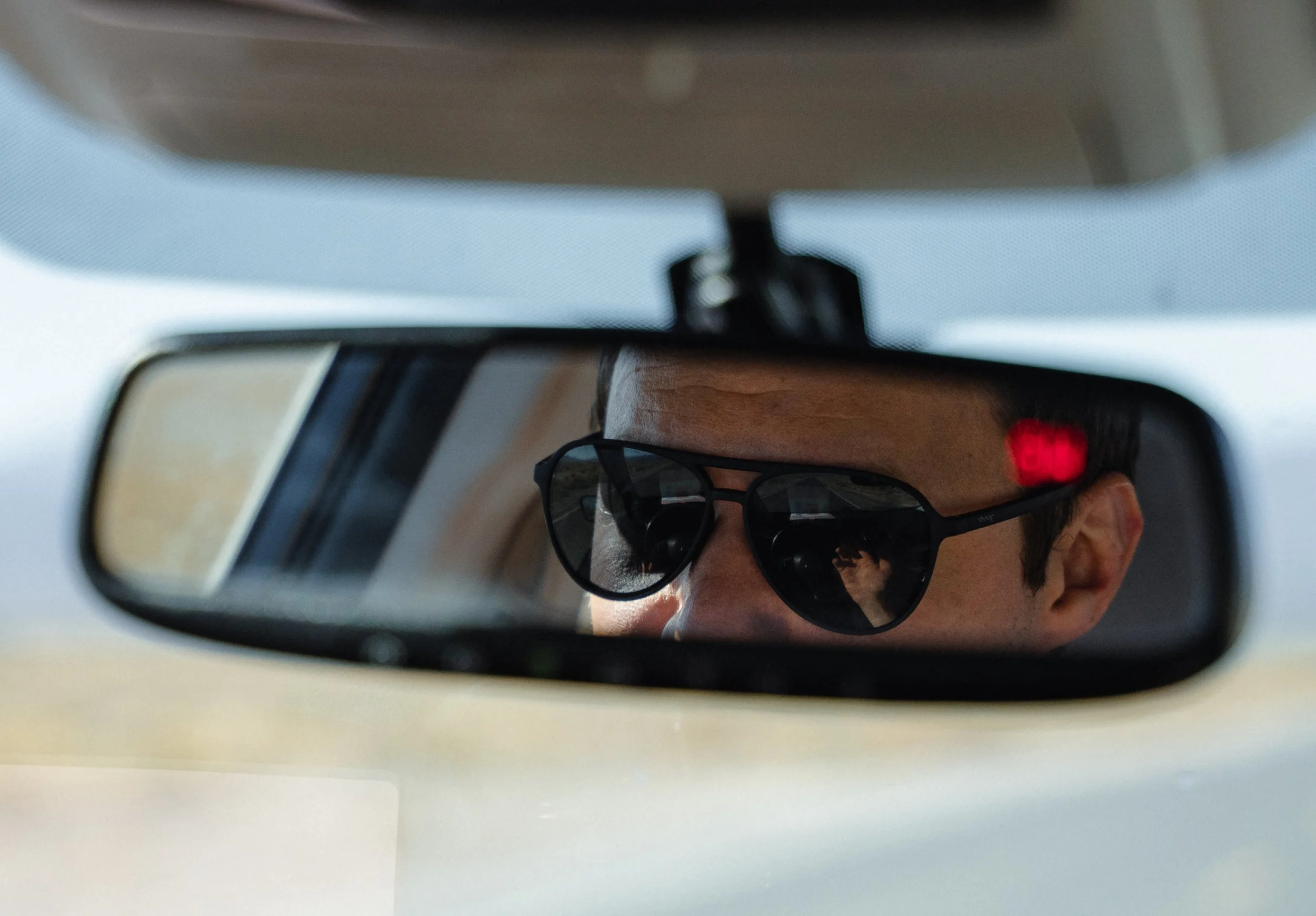 Mason Voehl, of the Amargosa Conservancy, drives between where he measures underground water levels and a close by idle zeolite mine in Amargosa Valley, Calif.