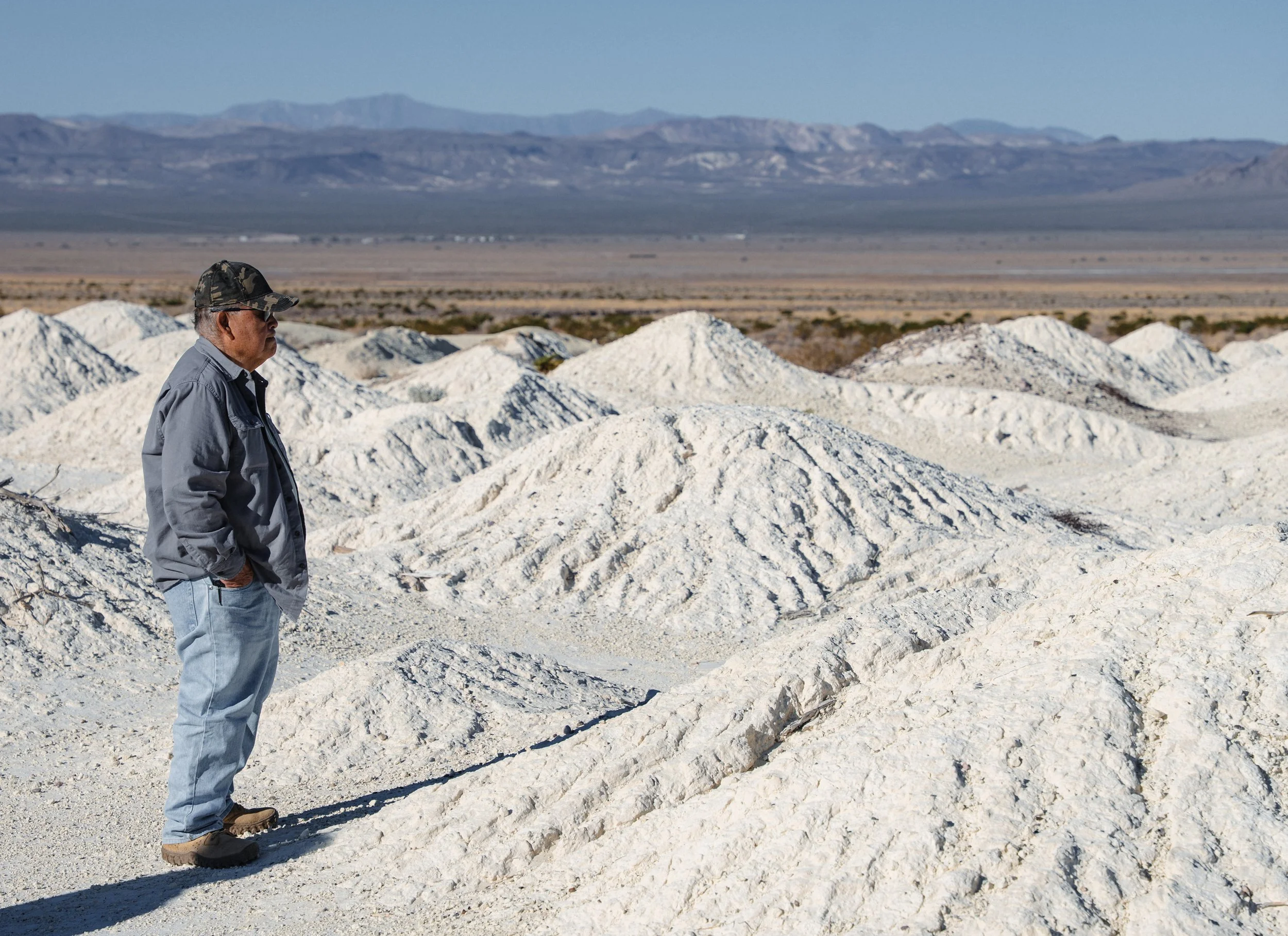 Ted James a Timbisha Shoshone Tribe elder studies the pulverized remnants.