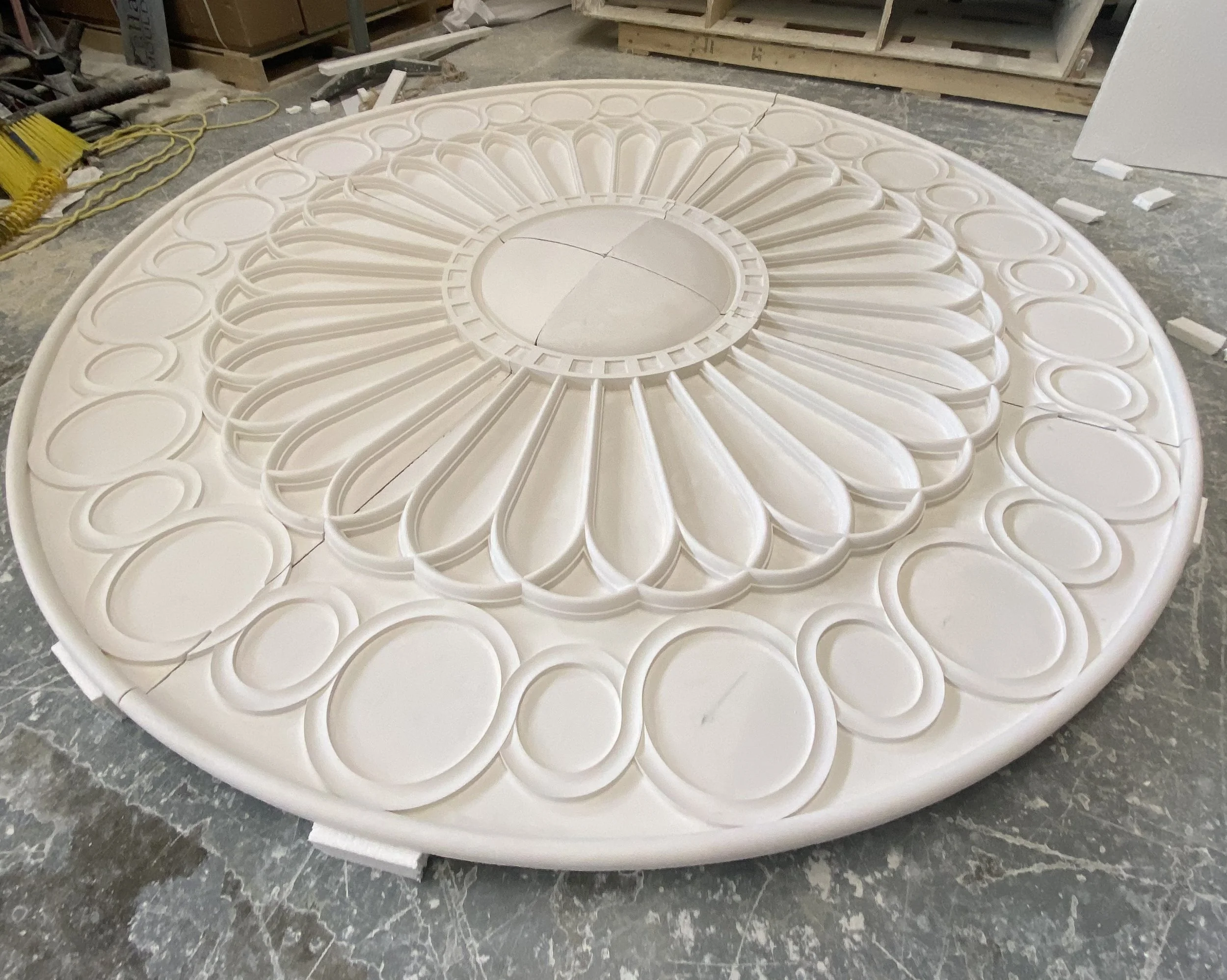 A large GFRG medallion is displayed with its circular and oblong patterns looking much like a classical interpretation of a daisy.