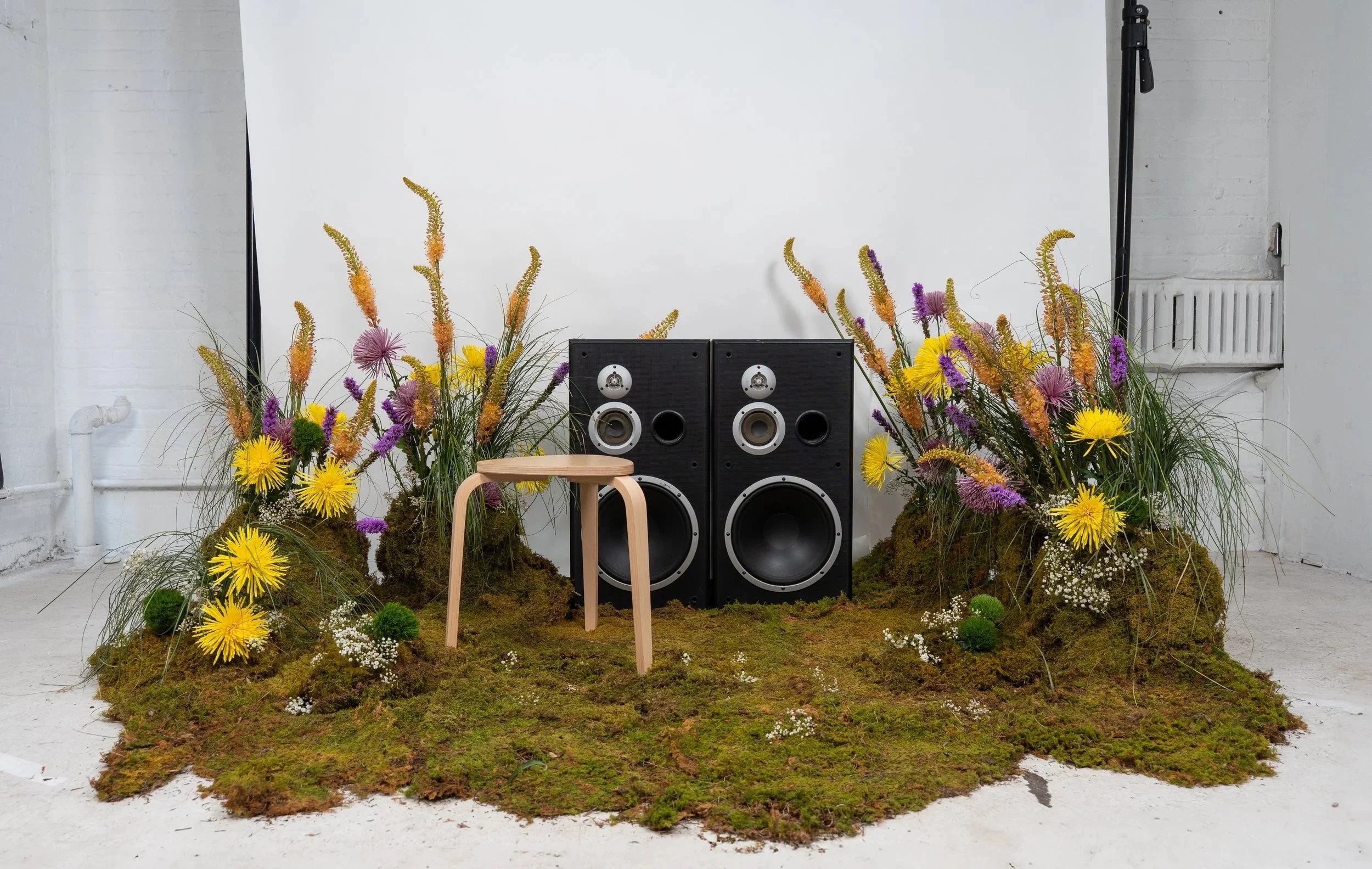 Custom floral installation blending organic textures and sculptural form for a Christian recording artist