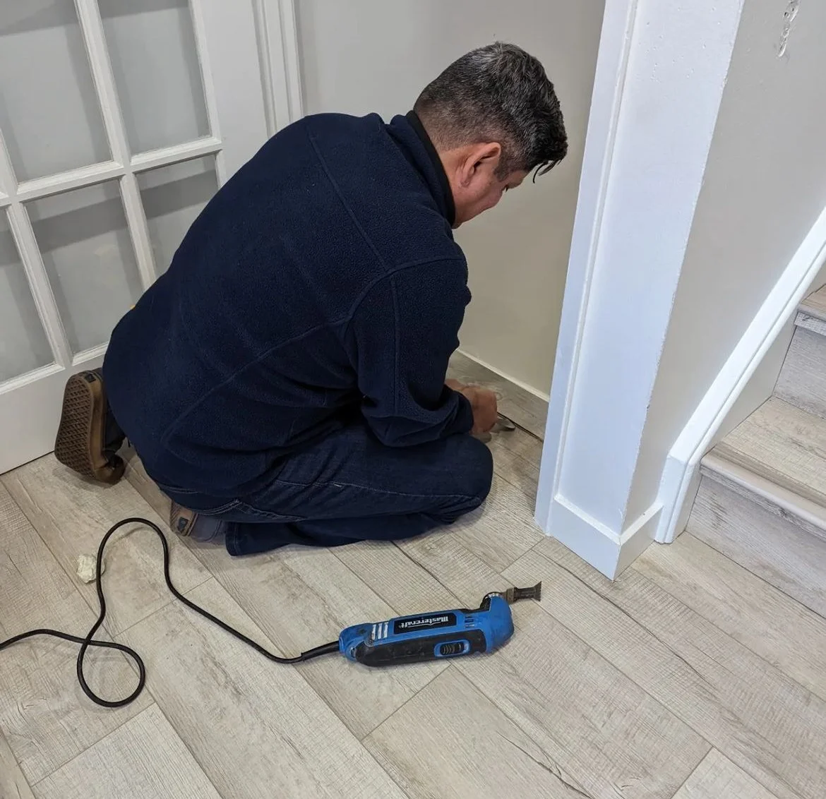 Joaquin Jimenez installing luxury vinyl flooring