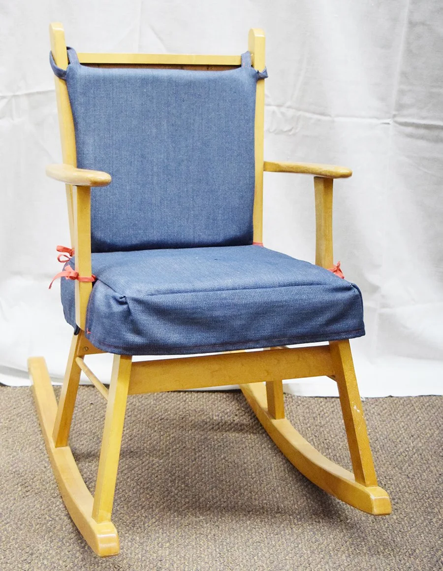 Child's wooden rocker with padded seat and back, solid back with light stain, 26" tall, seat 11" x 11"