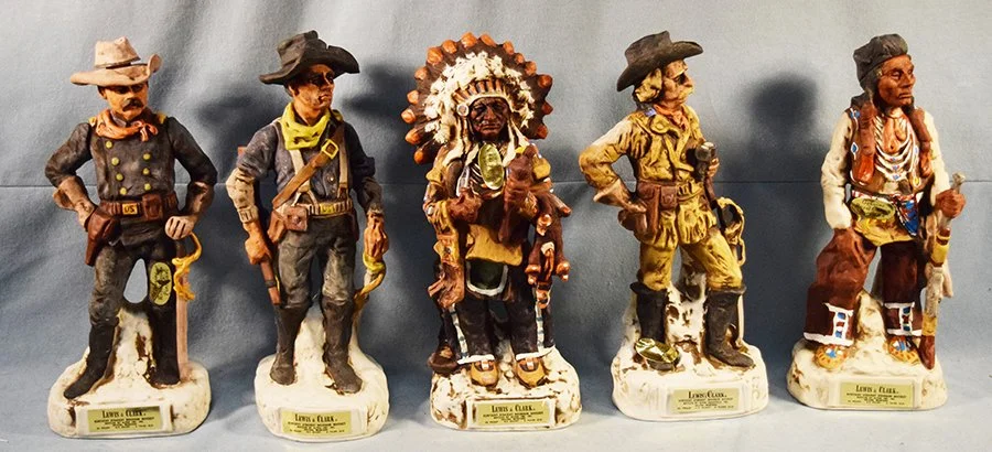 Schildt, Gary (1938-2021), Lewis and Clark Whiskey Decanters, Little Big Horn Centennial Series, Collector's # 5896, Genuine Royal Crown Porcelain. Major Reno, Trooper, Sitting Bull, Custer and Curlee - all are 14" x 6.25" x 4-6"
