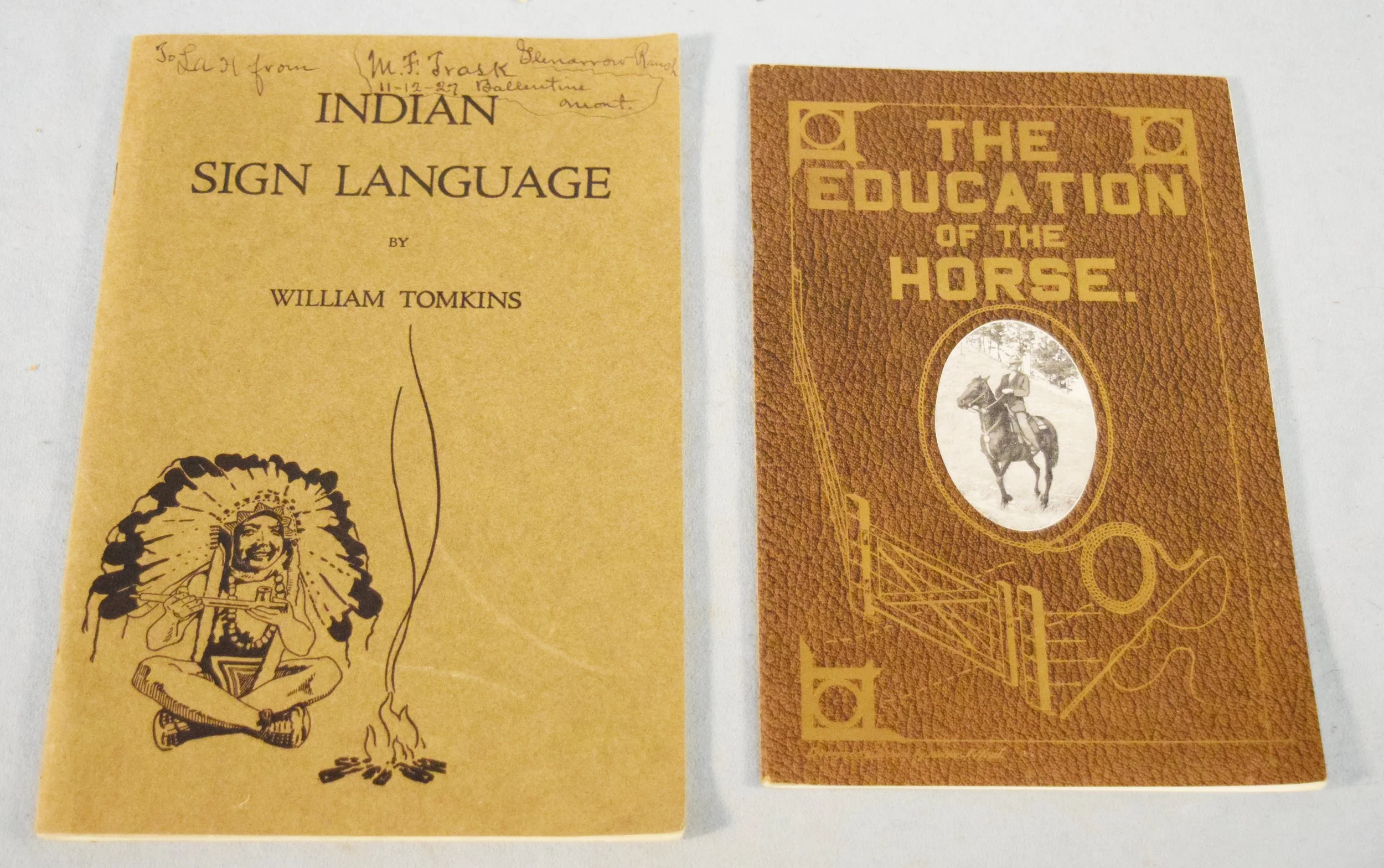 (2) Books previously owned by L.A. Huffman: Indian Sign Language by William Tomkins, 1926, inscribed "to LA from MF Trask 11-12-27" and The Education of the Horse by Walter J Neal, 1915, inscribed "to my friend LA Huffman - Walter J Neal - 2-24-17"