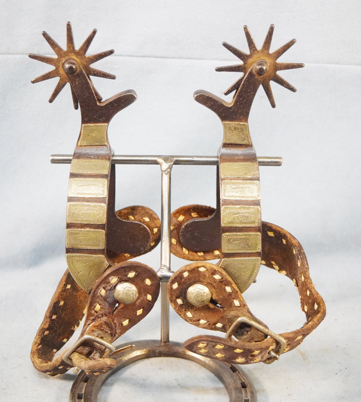 Unmarked silver mounted spurs with heel chains
