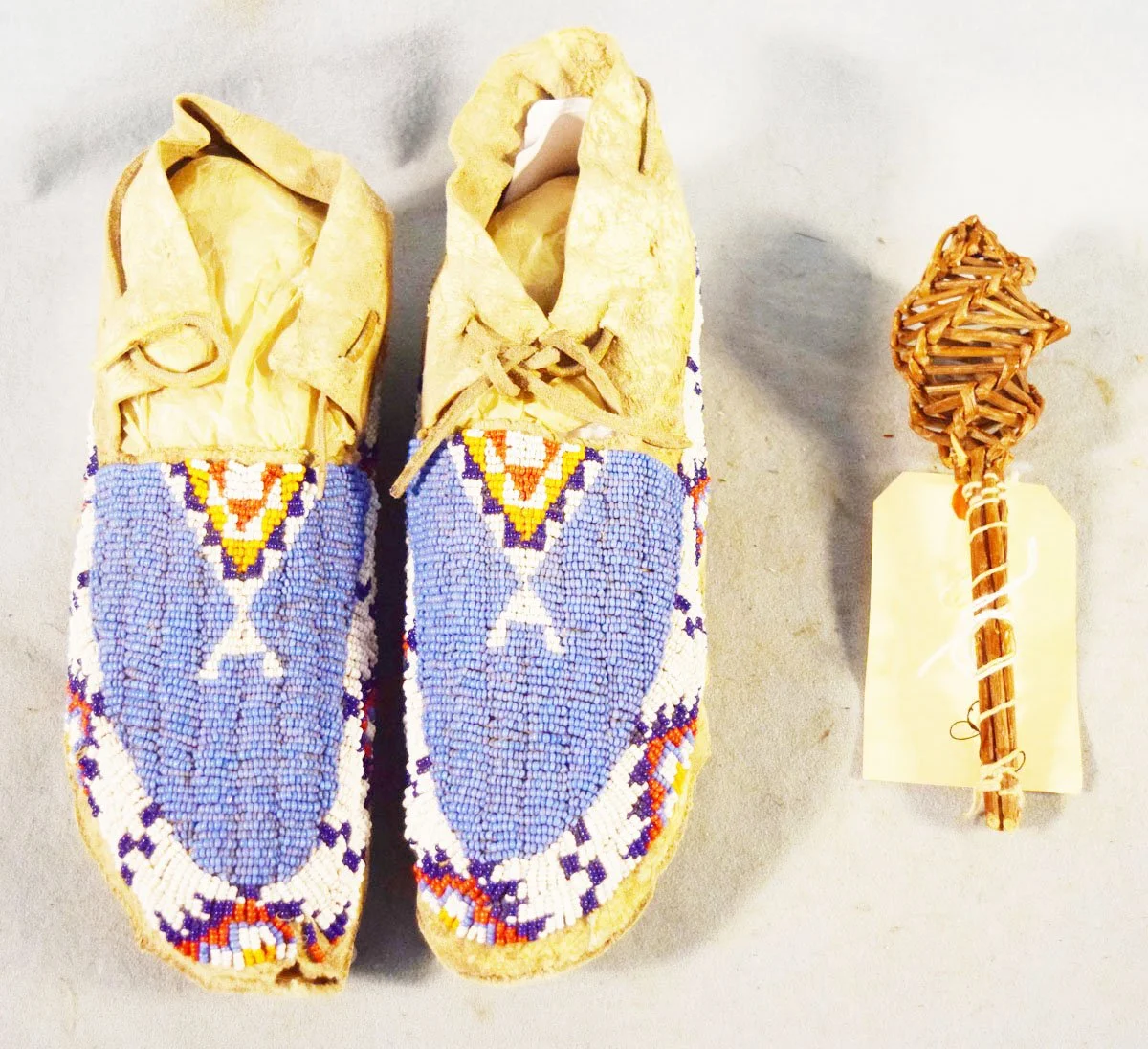 Indian-made baby rattle, hand made from reeds, 8" long & beaded moccasins, 10"", ca. 1900's 
